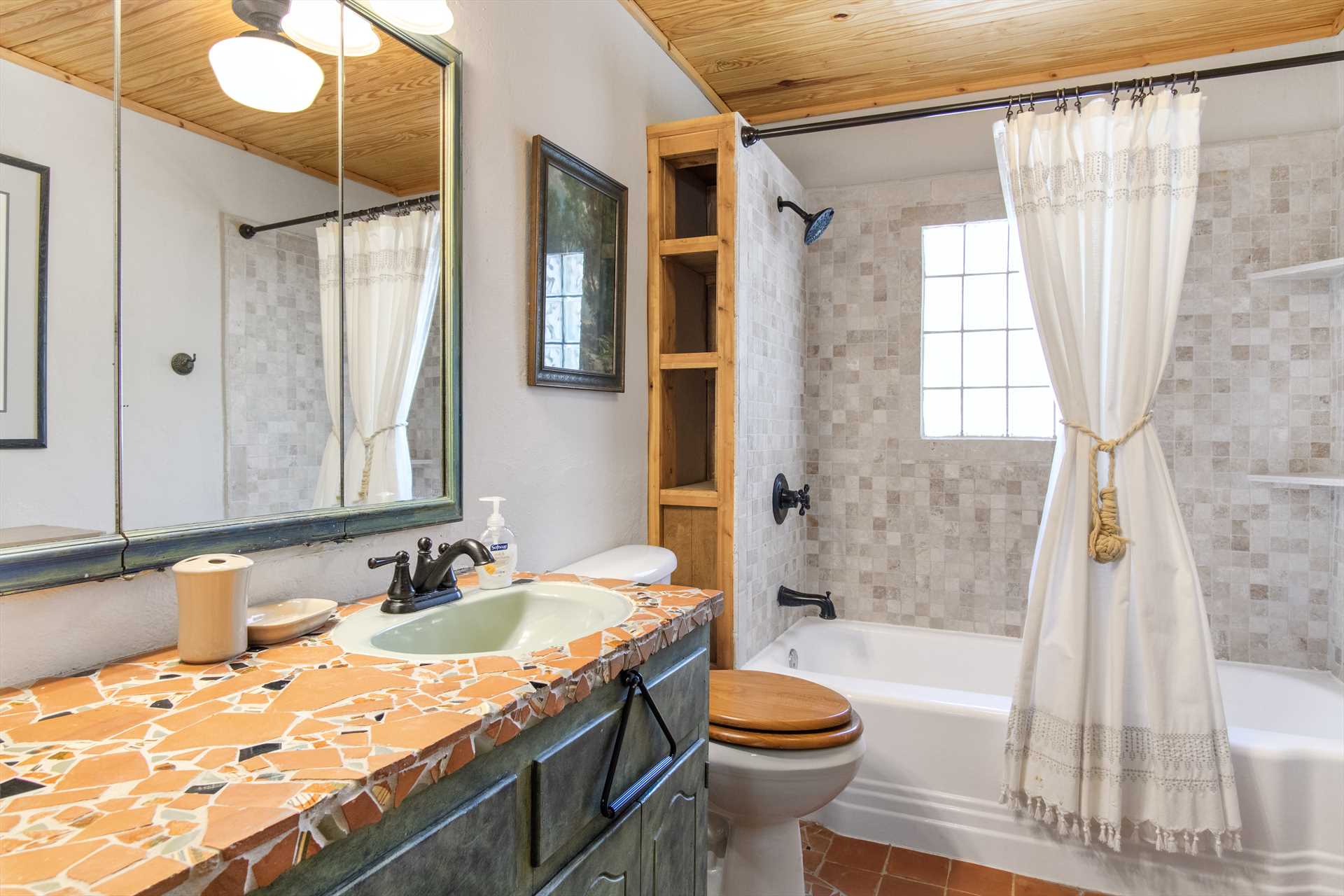                                                 This is just one of the three full baths here, featuring a roomy vanity and shower/tub combo.