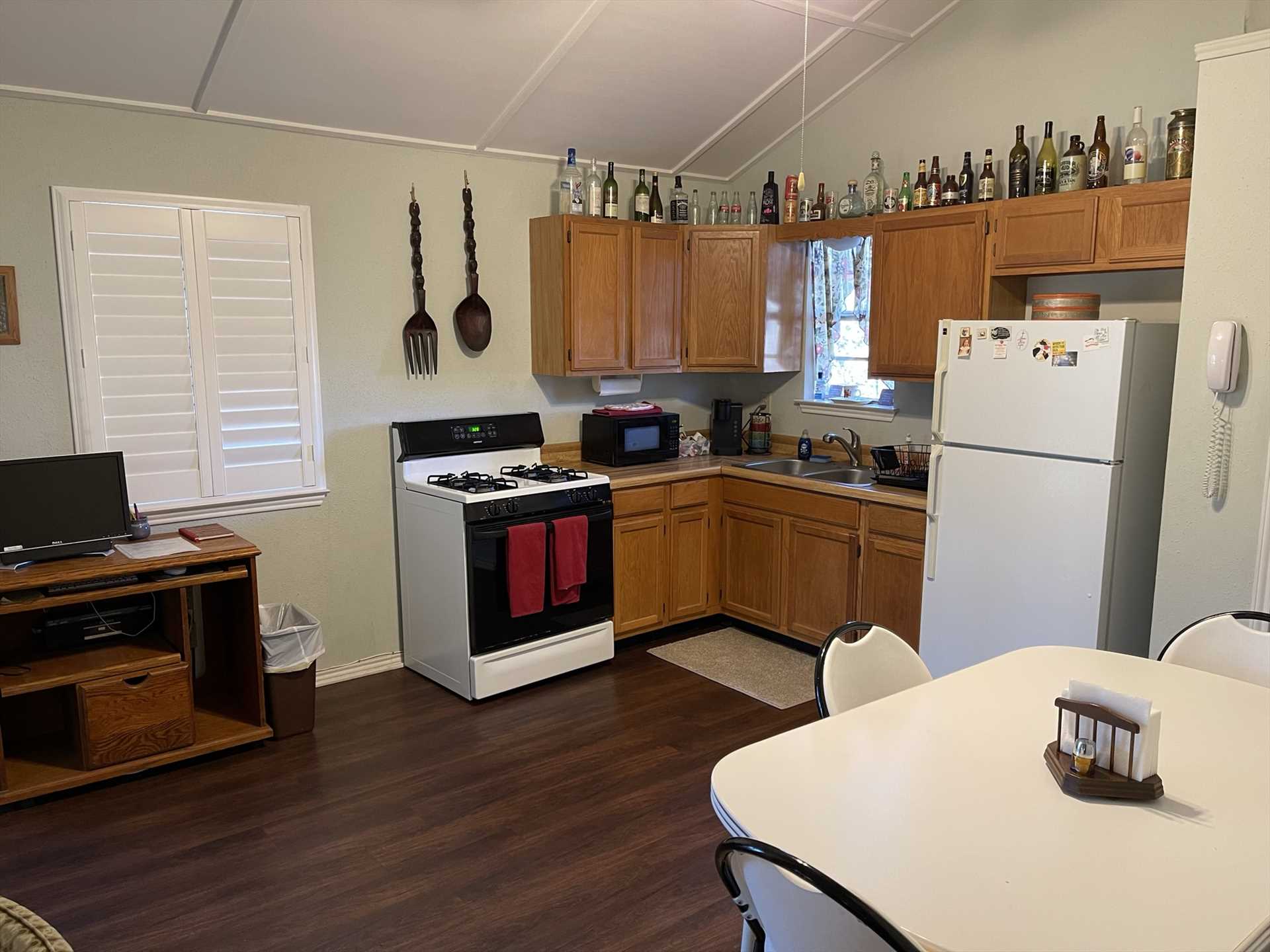                                                 The full kitchen has a fun personality all its own! It's equipped with appliances and utensils, as well as a cozy dining area.