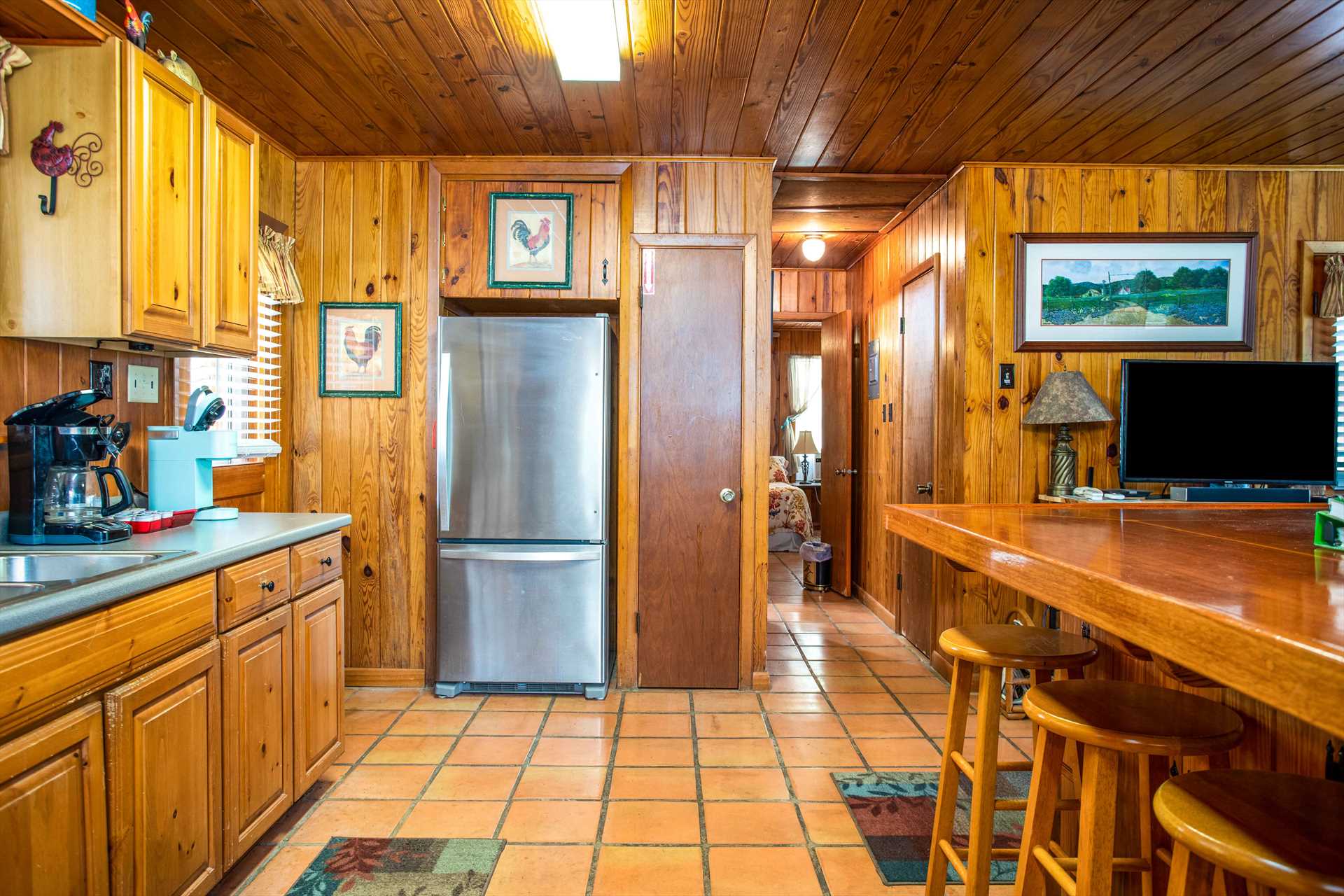                                                 Fun and homey decor can be found throughout the cabin, and this photo shows the sleeping areas are nicely separated from the kitchen and living areas.