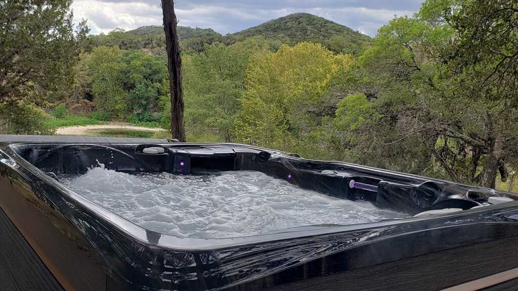                                                 Sink into the soothing bubbles of the hot tub...and while you're at it, check out that view!