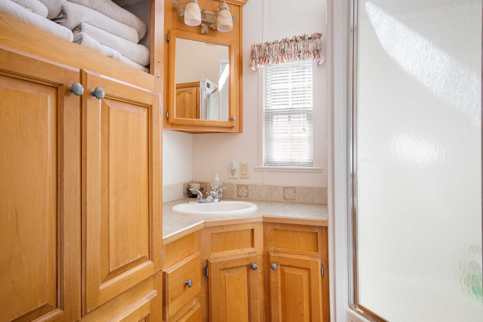                                                 The cabin's immaculate full bath includes a shower stall and plenty of clean linens.
