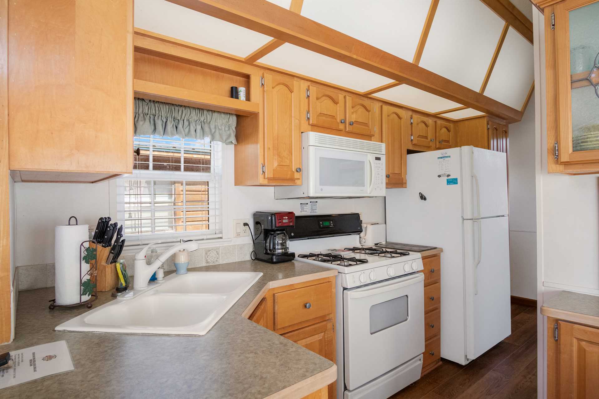                                                 The full kitchen here includes not only appliances and a coffee maker, but basic utensils, too.