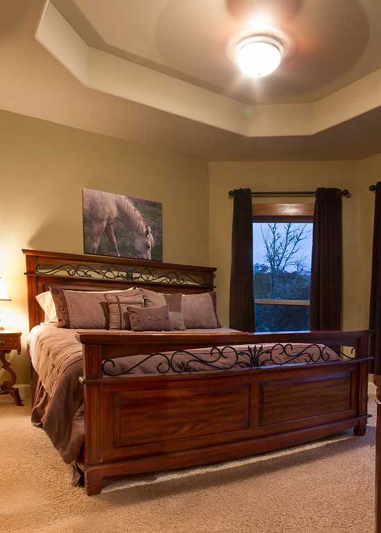                                                 A sleigh-style queen bed provides peaceful and comfortable slumber in the second bedroom.