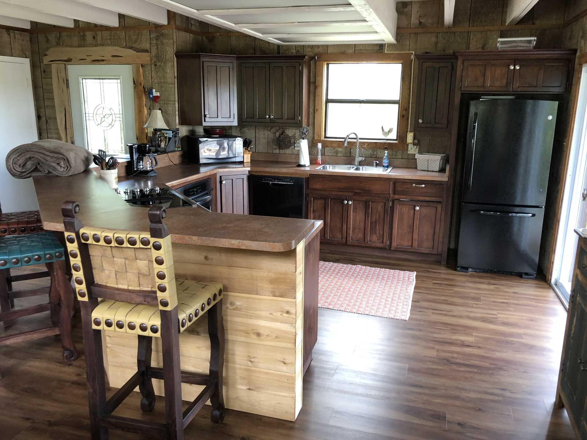                                                 A fully functional country kitchen is framed in gorgeous woodwork, just like the rest of the Bluff House.