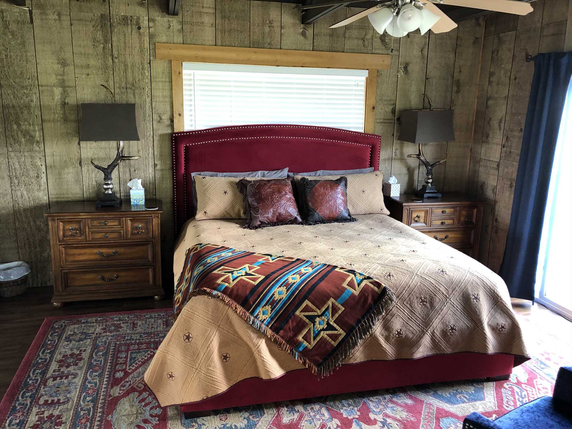                                                 In the master bedroom of the Bluff House, you'll find a comfy and warm king-sized bed, tastefully draped in fresh linens.