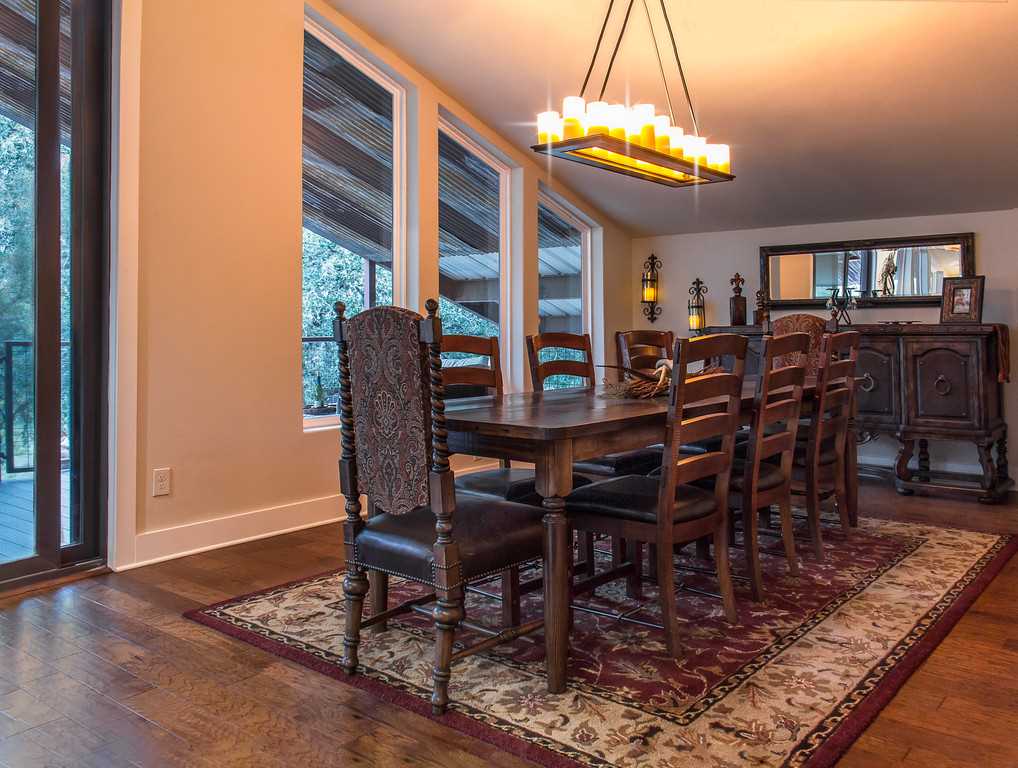                                                 Beautifully-crafted woodwork highlights the Barndominium's dining table. It seats up to eight, which is perfect for mealtimes and game nights!