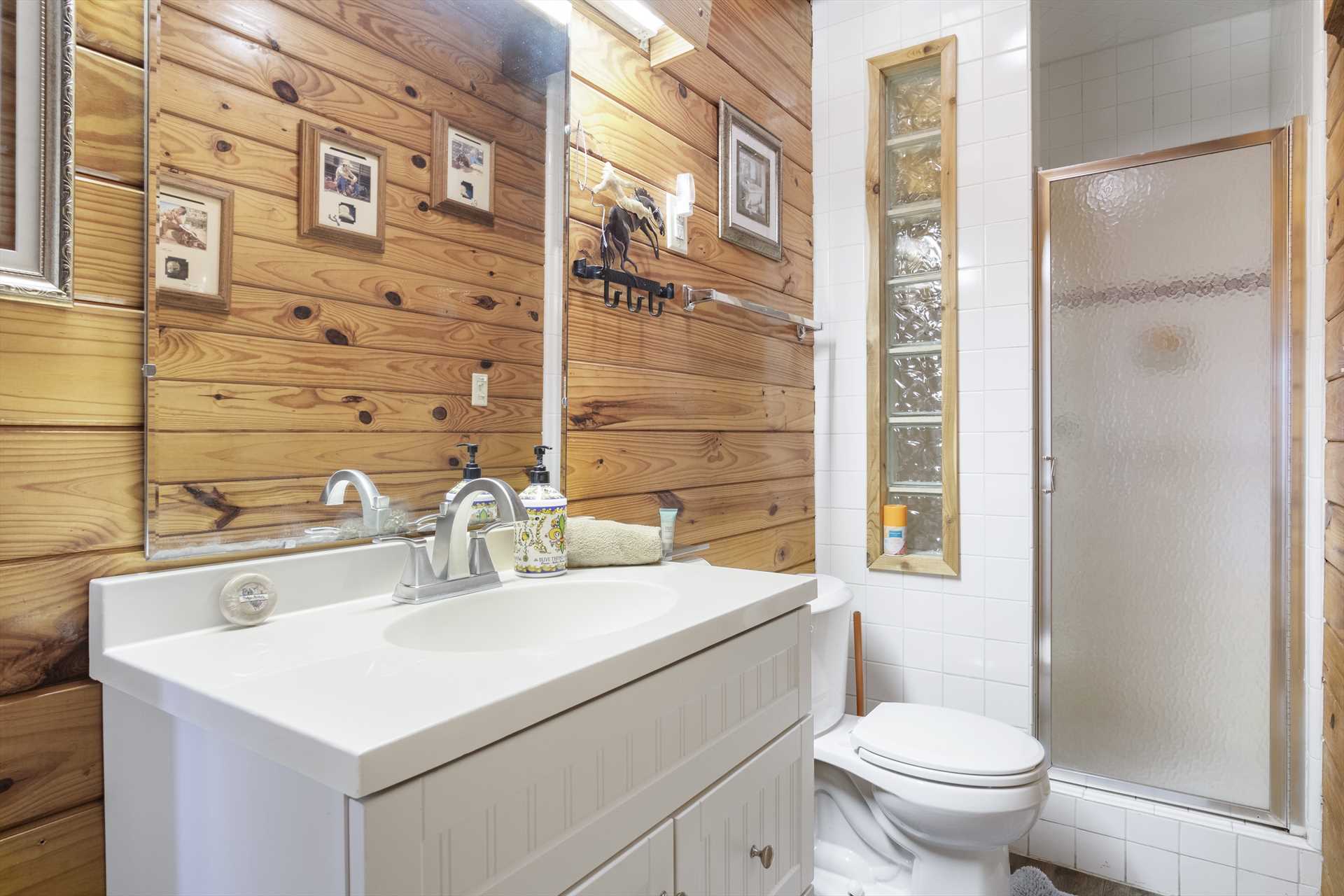                                                 A roomy vanity, shower stall, and clean and fluffy linens are all included in the full bath.
