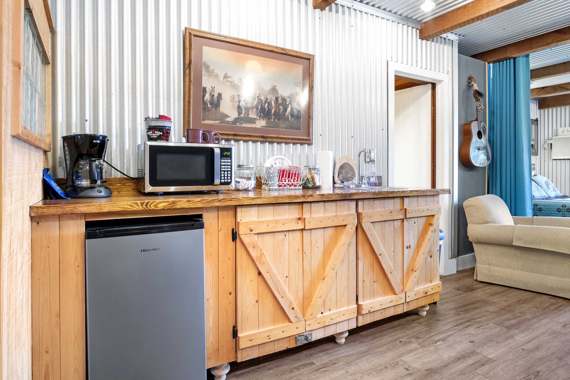                                                 The Hideaway Cabin's convenient kitchenette includes a mini fridge, microwave, and coffee maker.