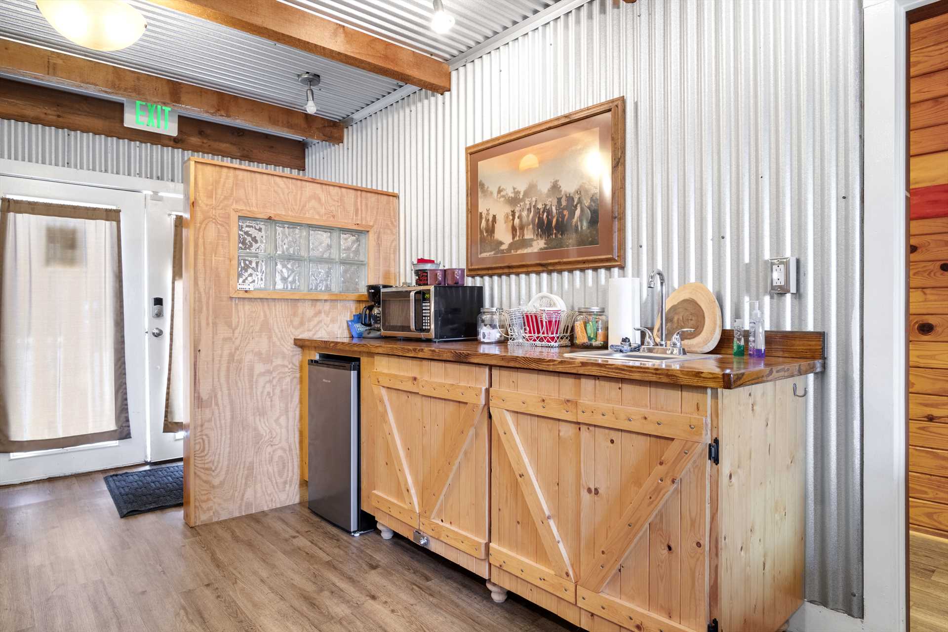                                                 Barn-style woodwork and corrugated steel give the Hideaway Cabin a rustic ranch feel, it's perfect for the Cowboy Capital of the World!