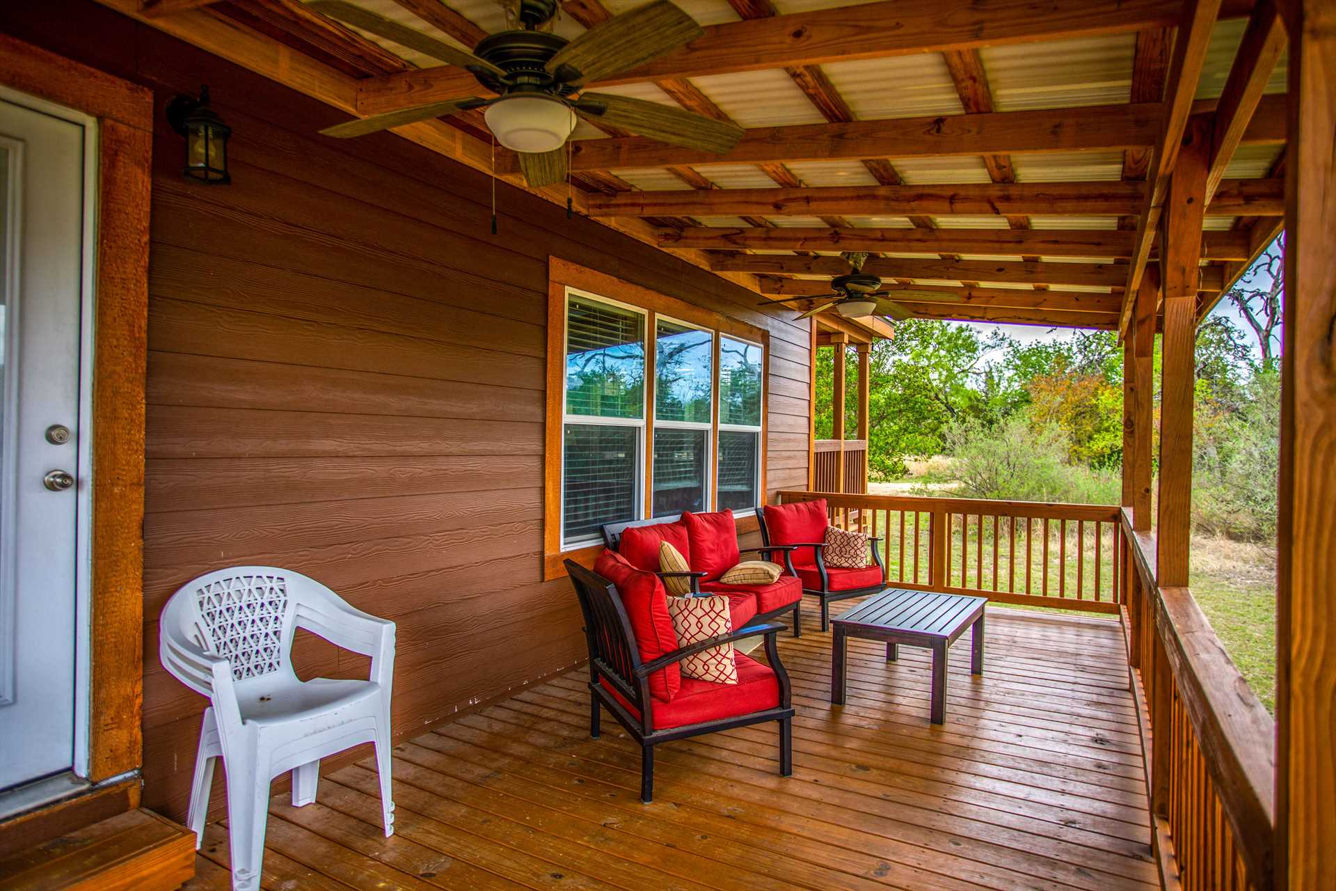                                                 Have a seat in cushioned comfort on the deck, and set the ceiling fans spinning for a cool breeze!