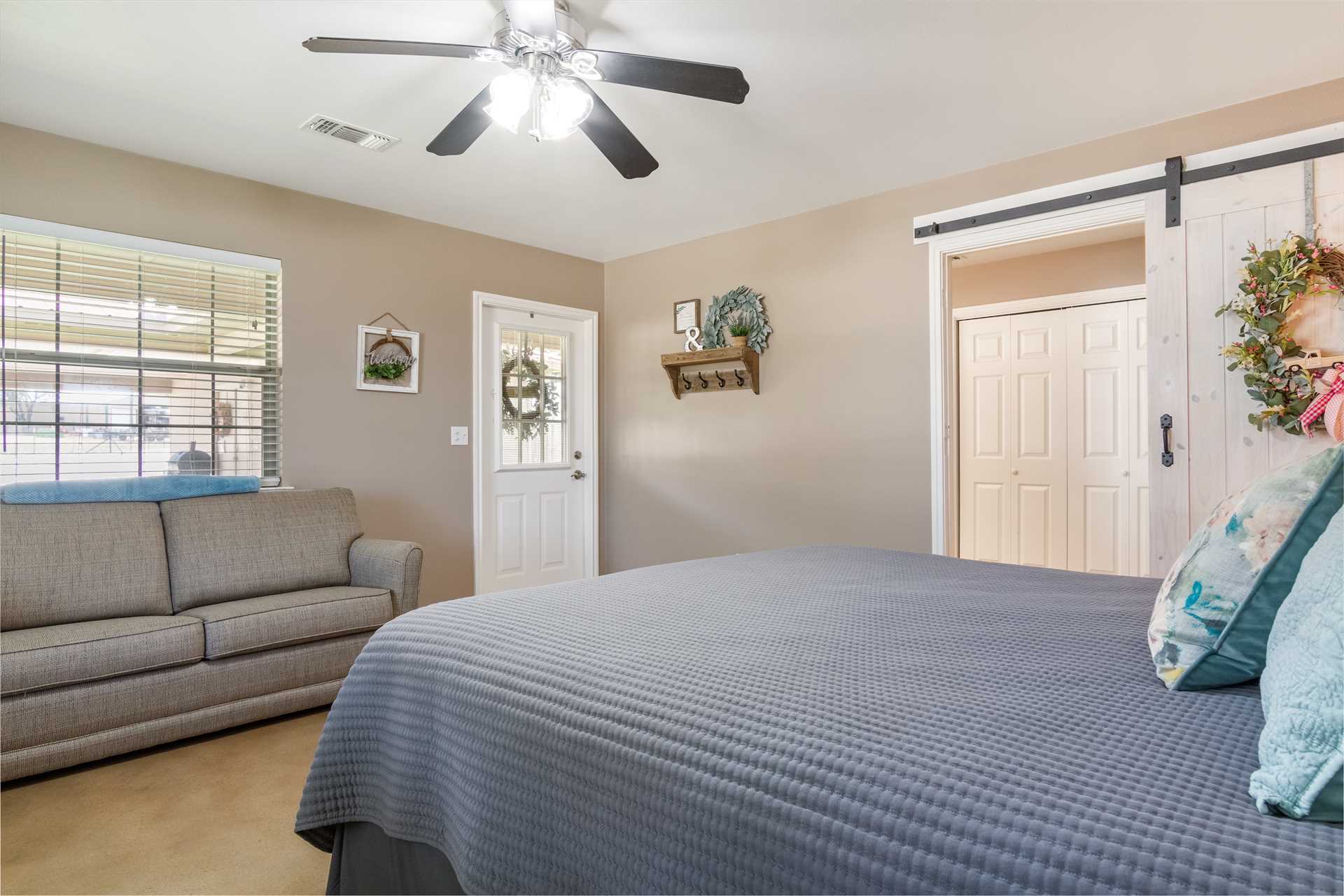                                                 Two of the three bedrooms here have private doors that open onto the shaded patio.