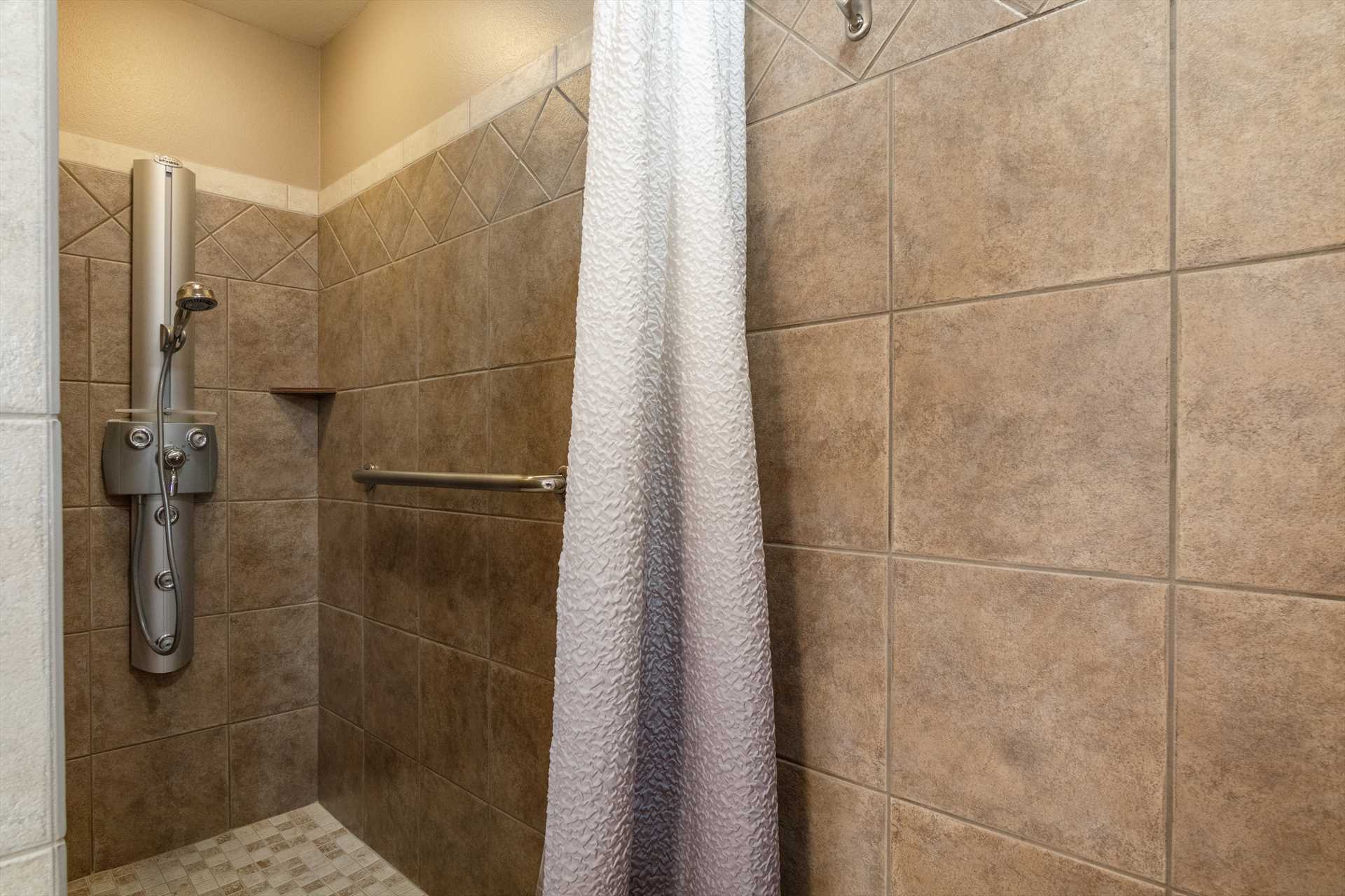                                                 A full-sized walk-in shower is the central cleanup feature in the first full bath.