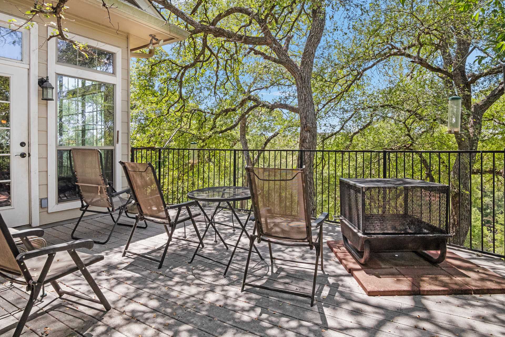                                                 Dappled shade and sunlight on the deck keep things cooler, with plenty of outdoor furniture for everyone.