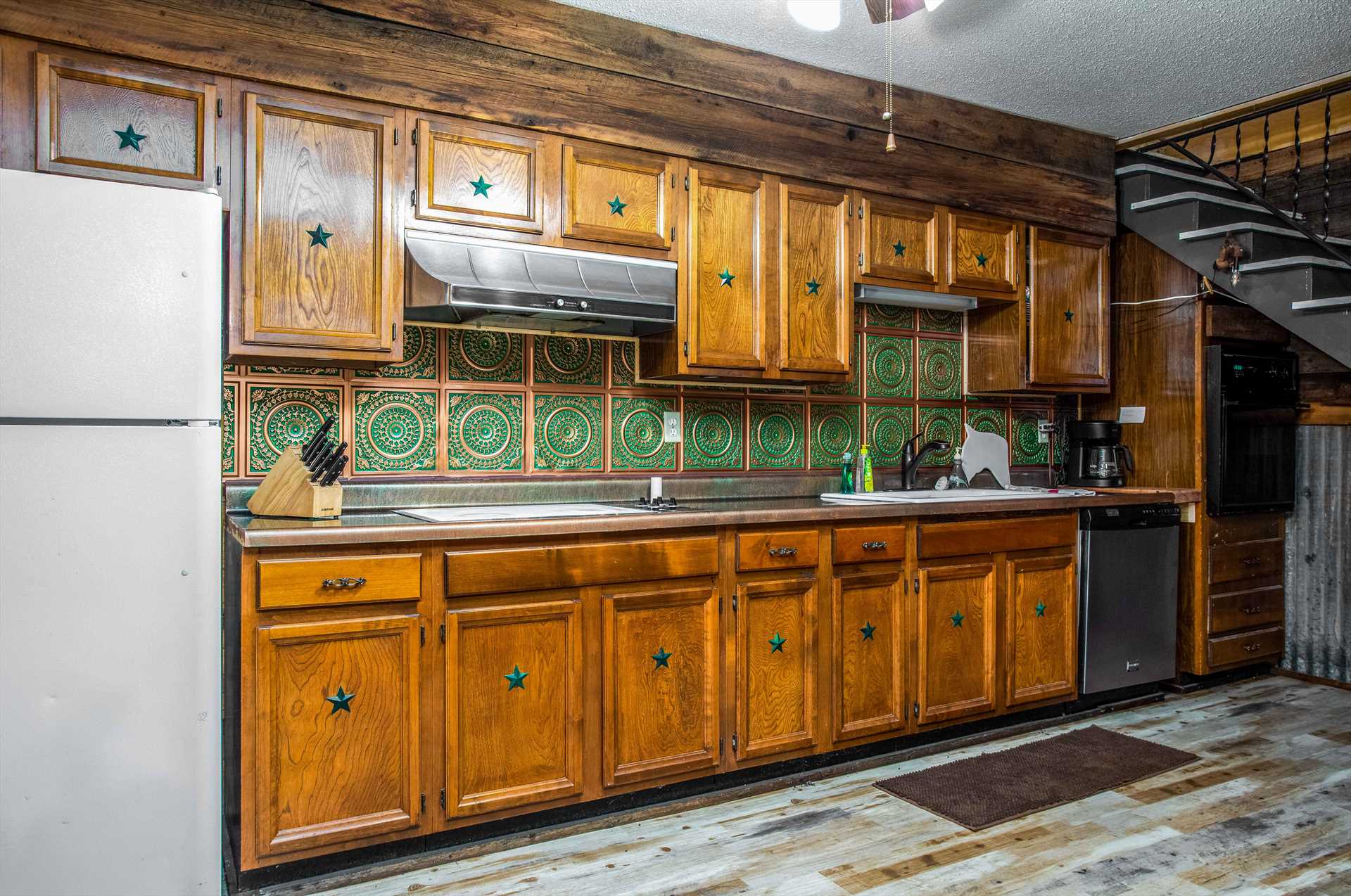                                                 The Lone Star-themed cabinetry in the kitchen contains all the cooking ware, serving ware, utensils, and glasses you'll need for even the biggest meals!