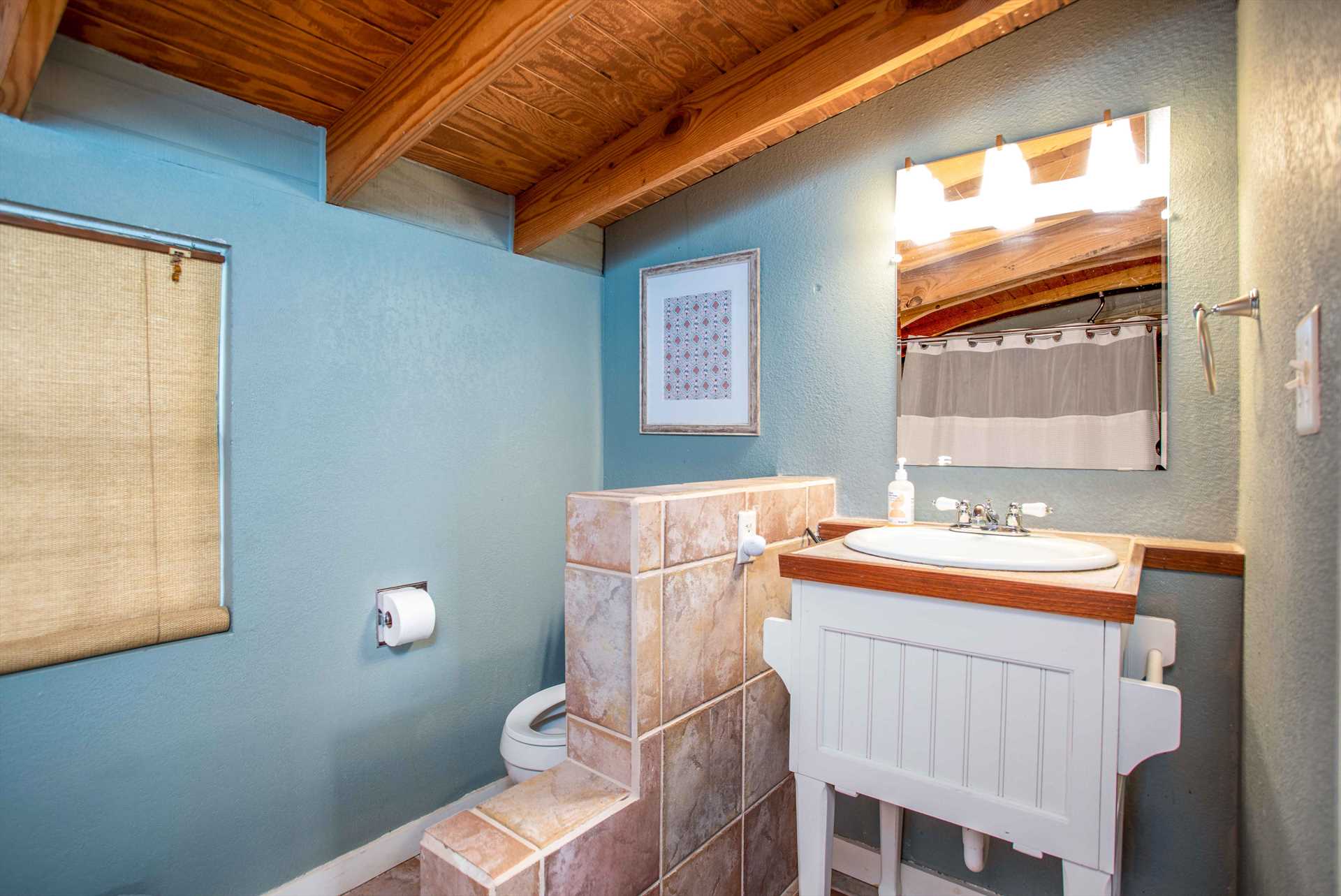                                                 Next to the vanity in the second bathroom, you'll find a convenient half-wall where you can keep your toiletries!