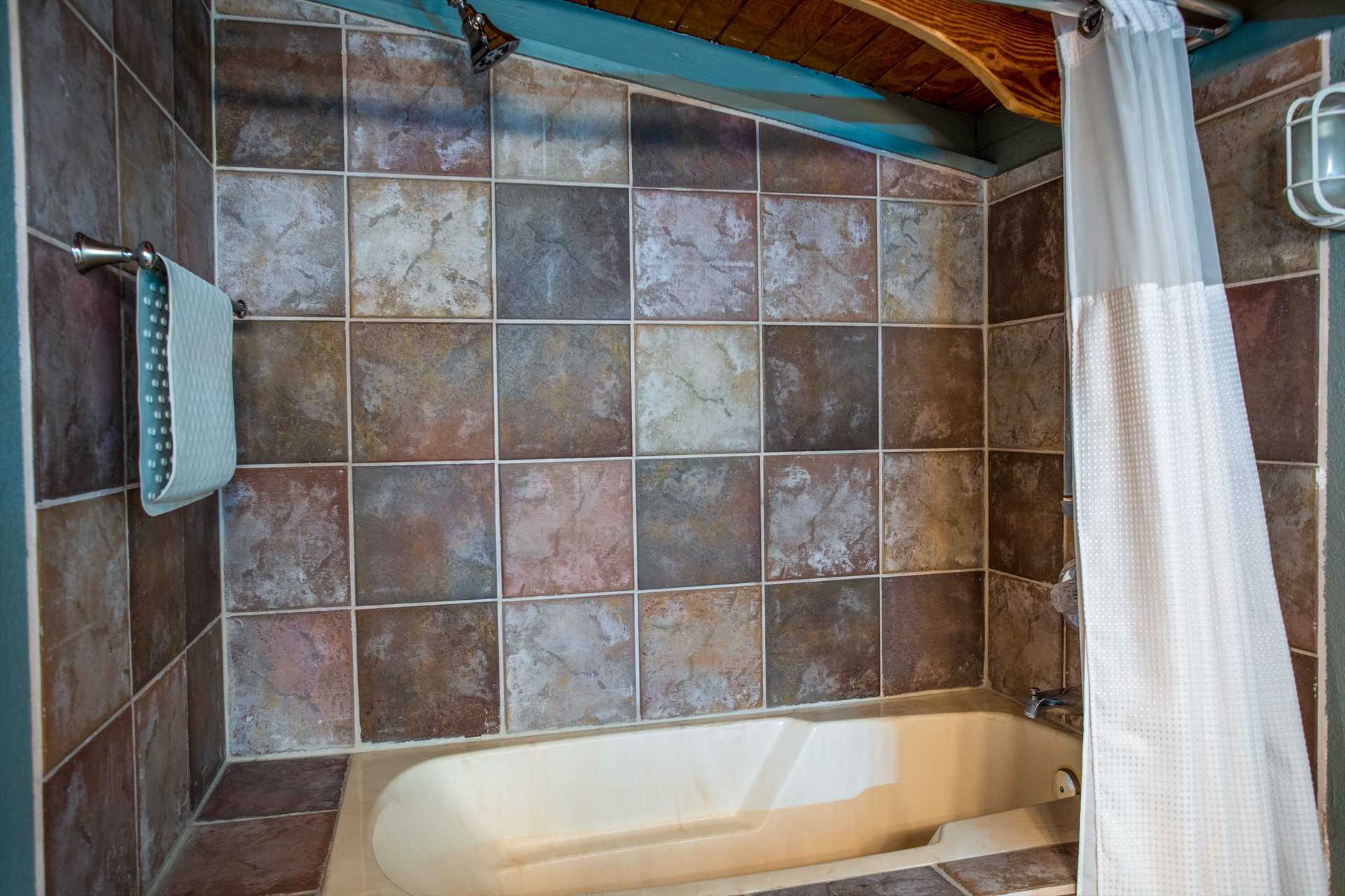                                                Stylish tile work and a shower/tub combo make the second bath a tidy and classy cleanup space!