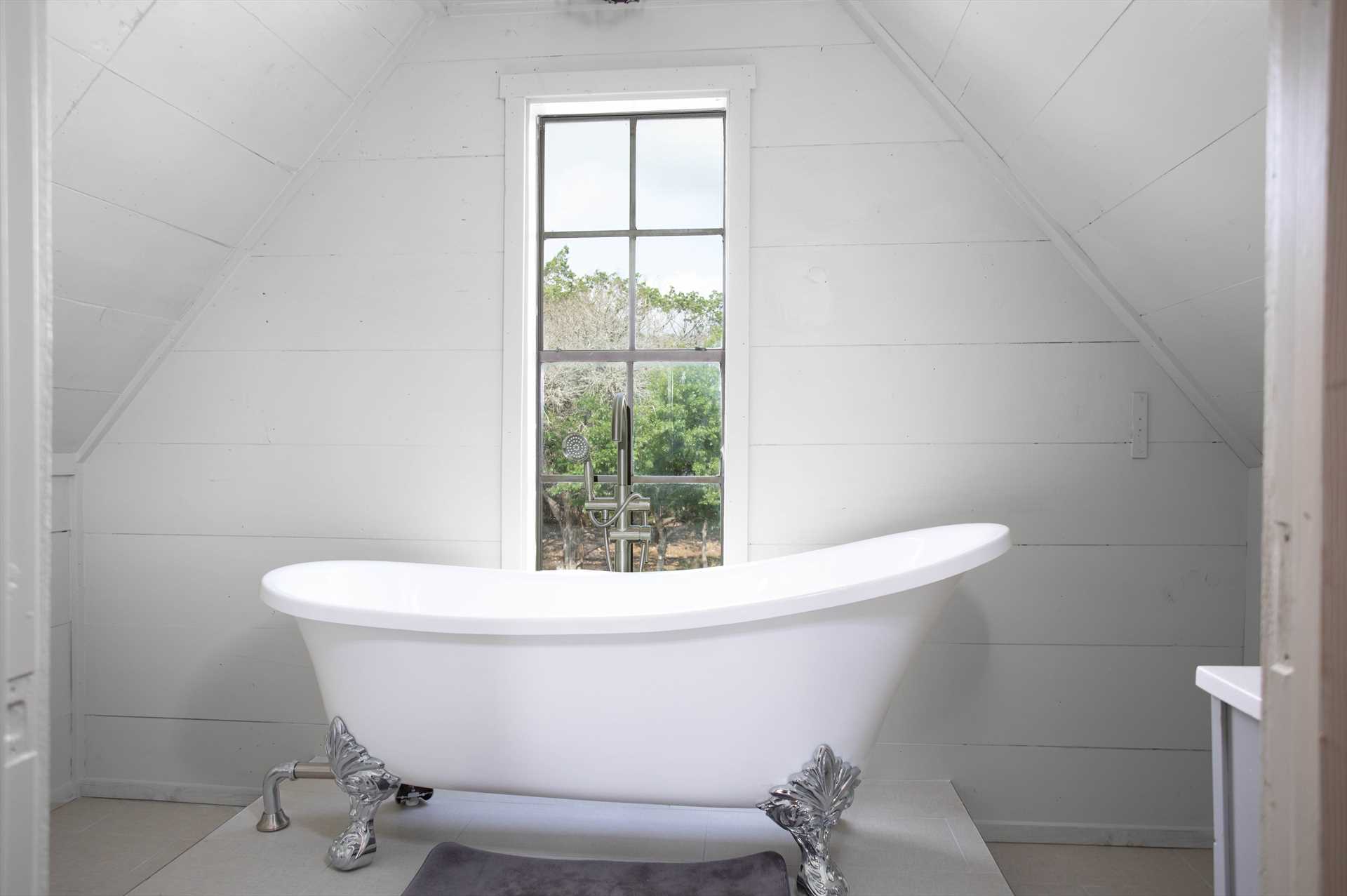                                                 The clean and bright space of the second full bath has a nostalgic clawfoot tub as its centerpiece!