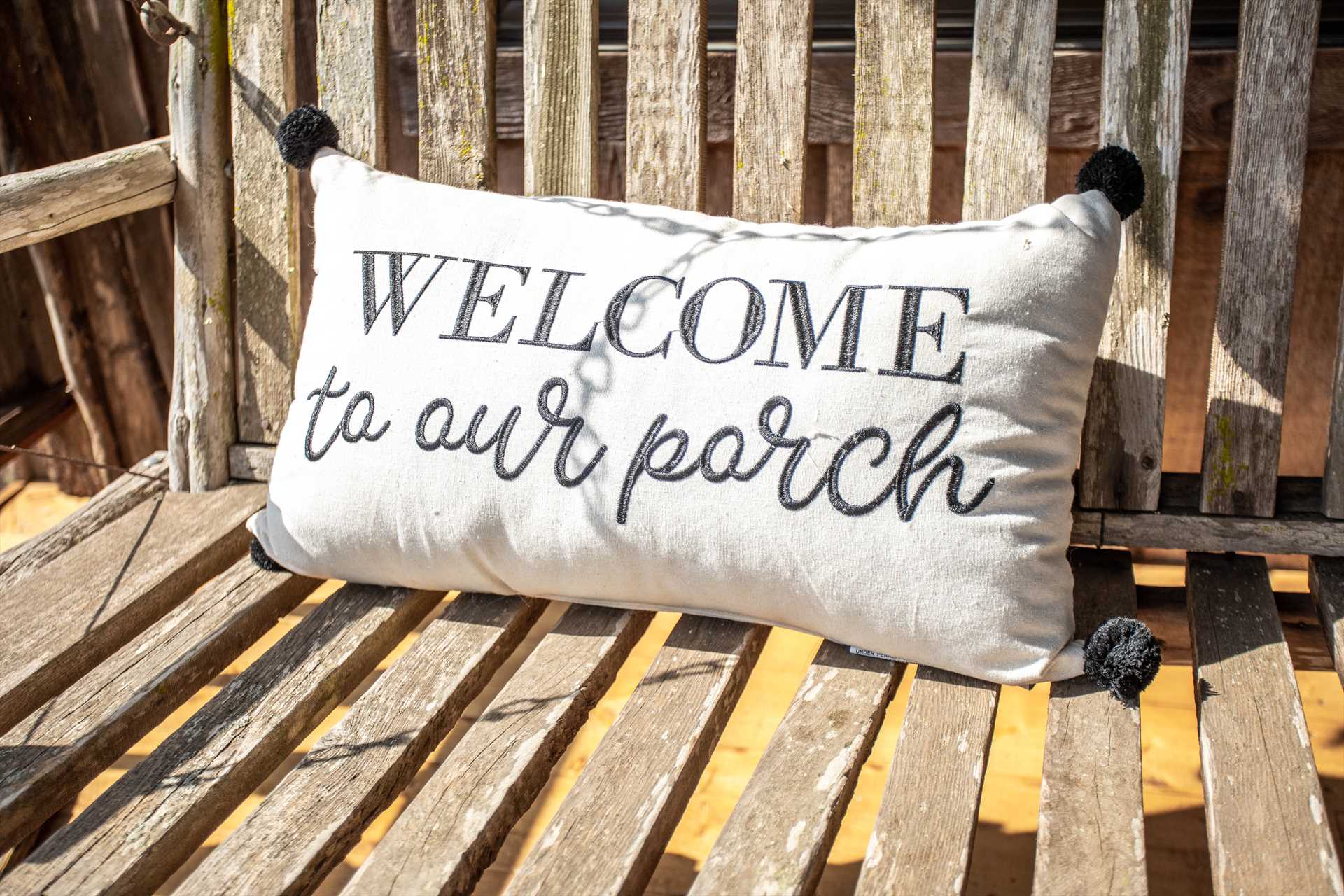                                                 Come and sit a spell! There's a comfy porch swing here with your name on it.