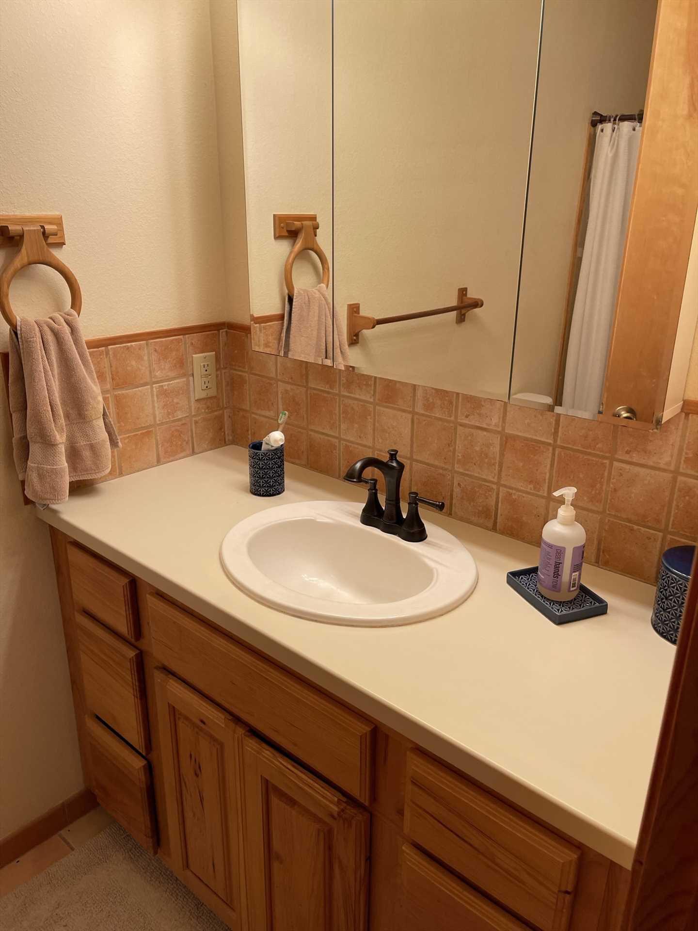                                                The Texas Longhorn Cabin has two full baths (the master bath is pictured here), and both come with basic toiletries and clean and fresh linens!