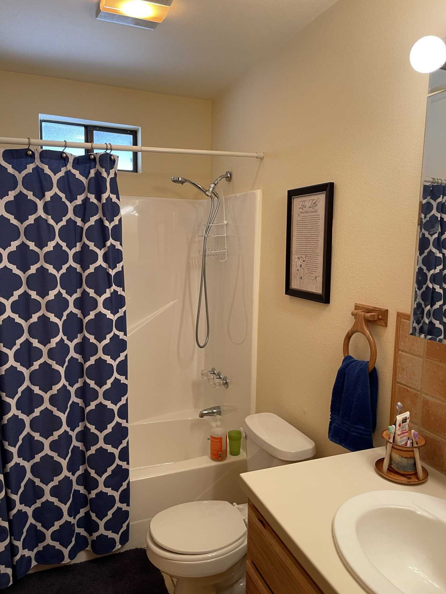                                                 The spotlessly-clean second bath includes a roomy tub and shower combo!