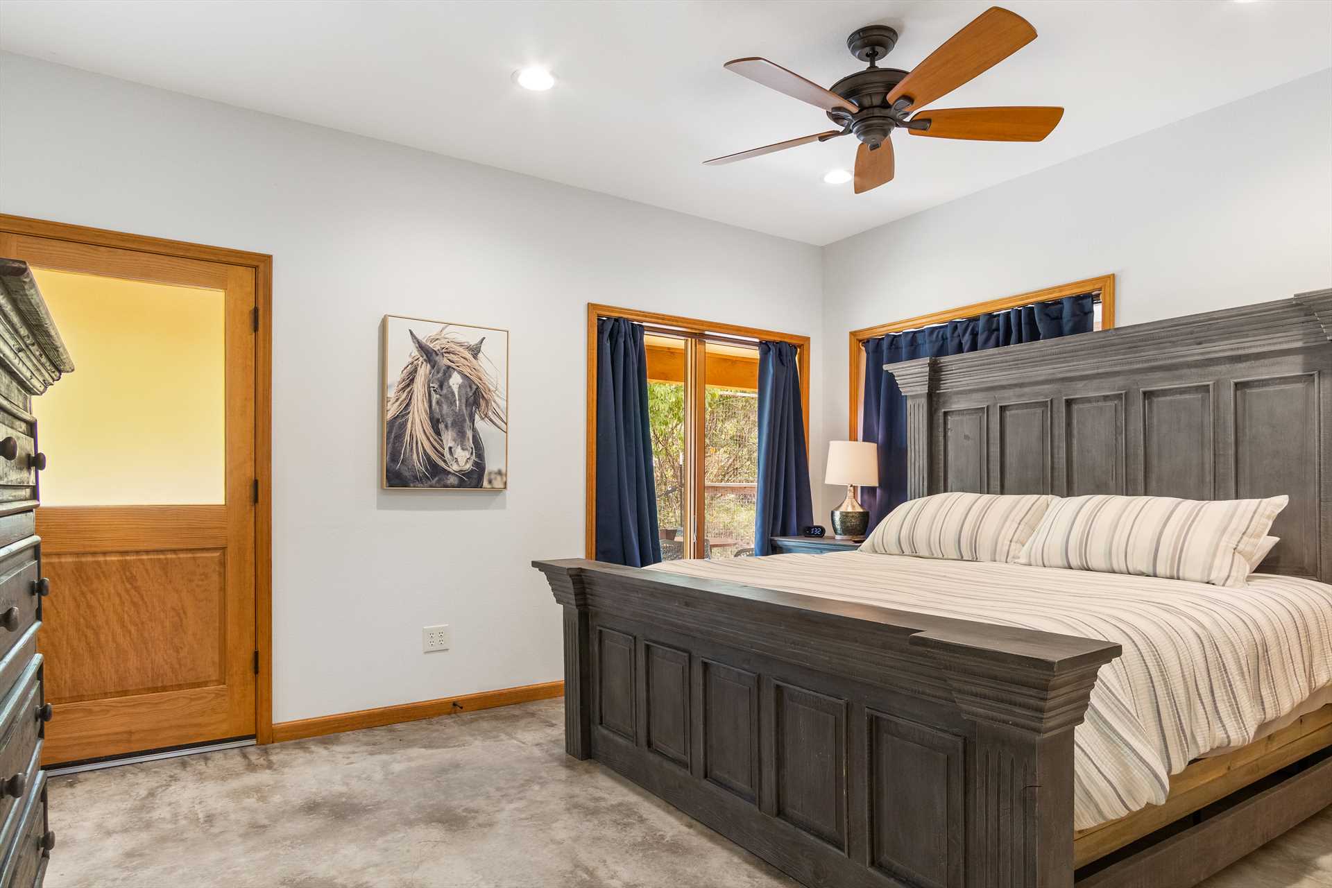                                                 A regal and comfortable king-sized bed can be found in the ranch's master bedroom, complete with fresh linens (as are all the sleeping spaces here).