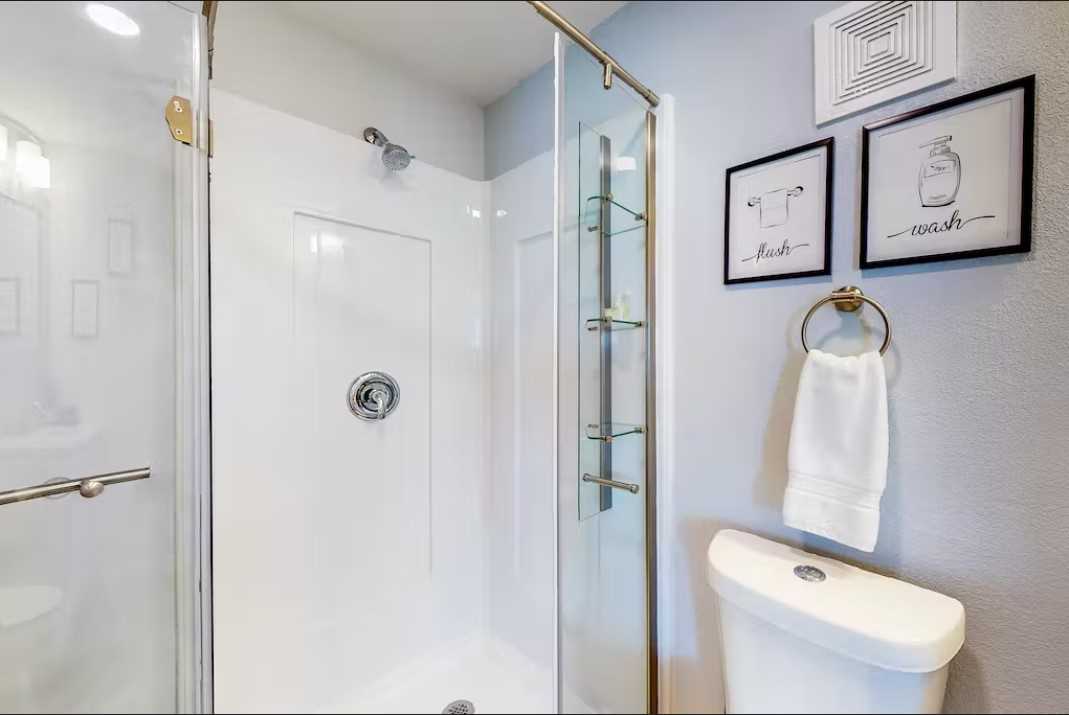                                                 The master bath at the Retreat features a sparkling-clean and roomy shower stall.