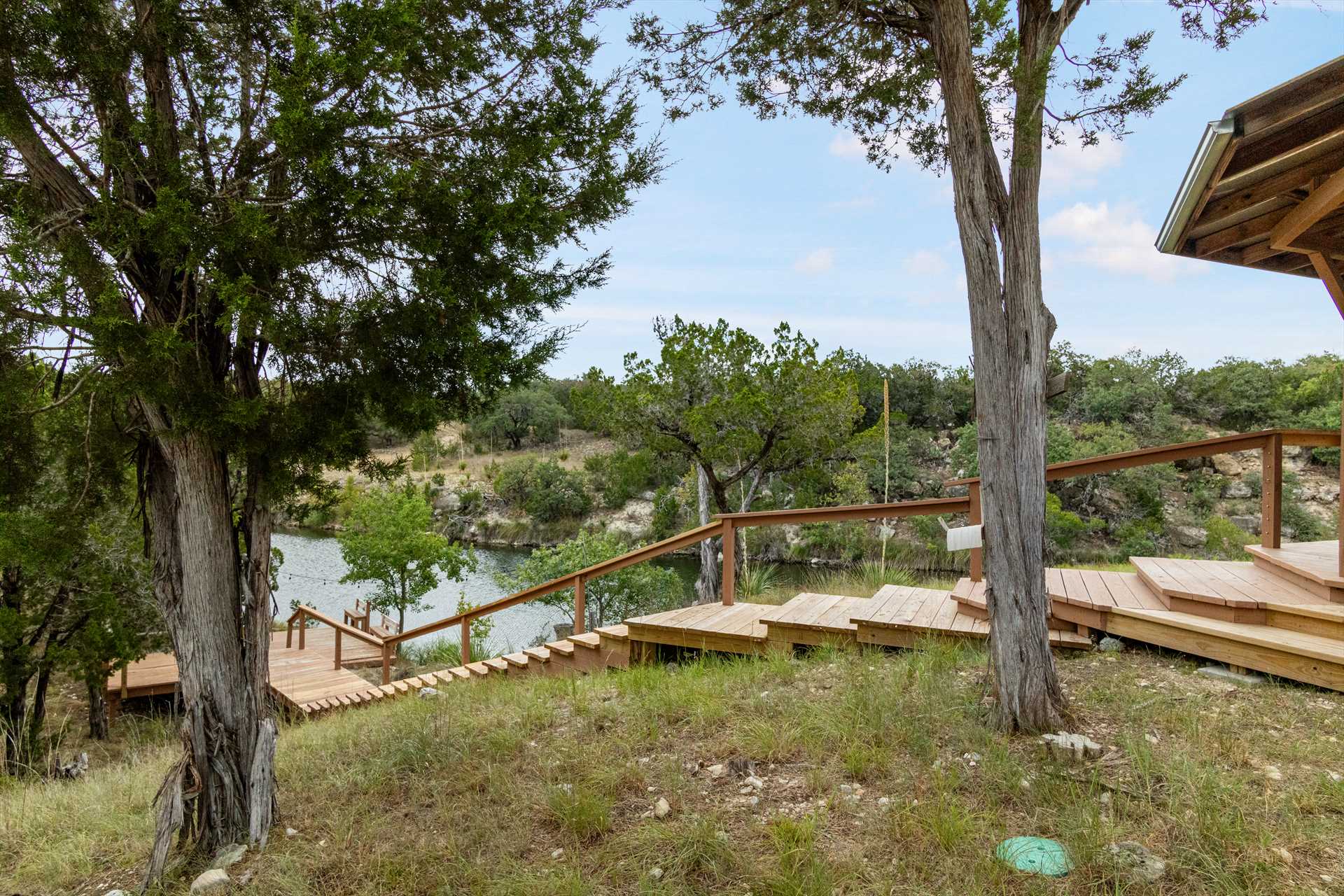                                                 This sturdy staircase is your gateway to the creek, leading from the back deck to your own private dock!