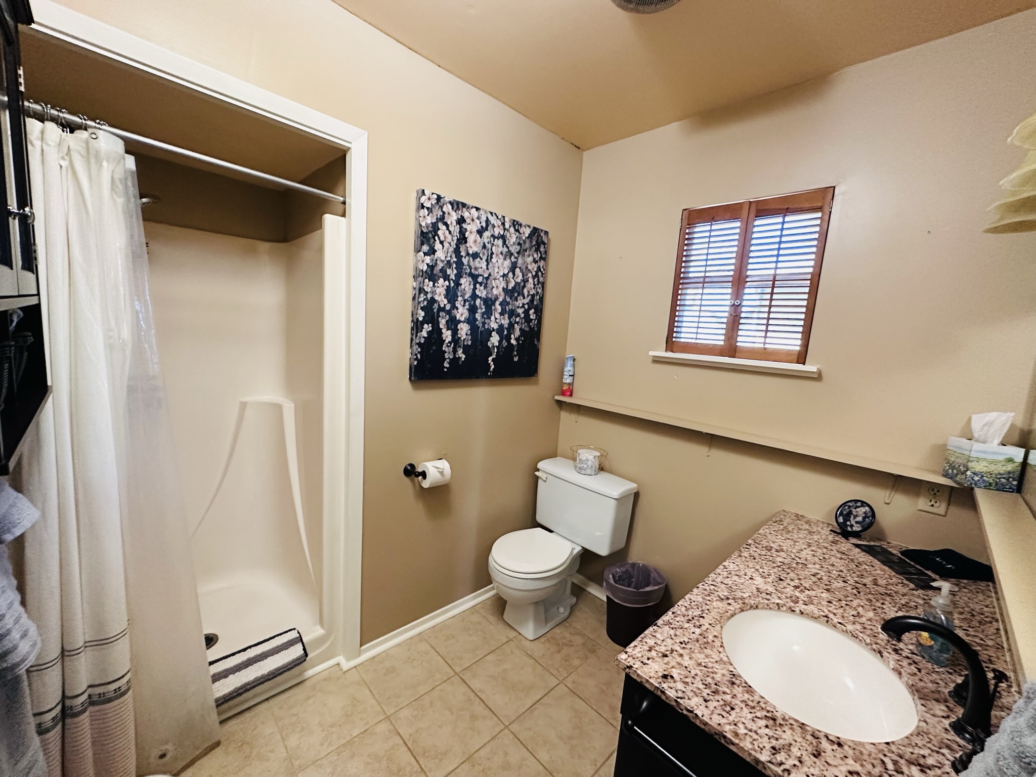                                                 Fresh linens are provided in the spotlessly-clean full bath, with a roomy shower stall and single vanity.