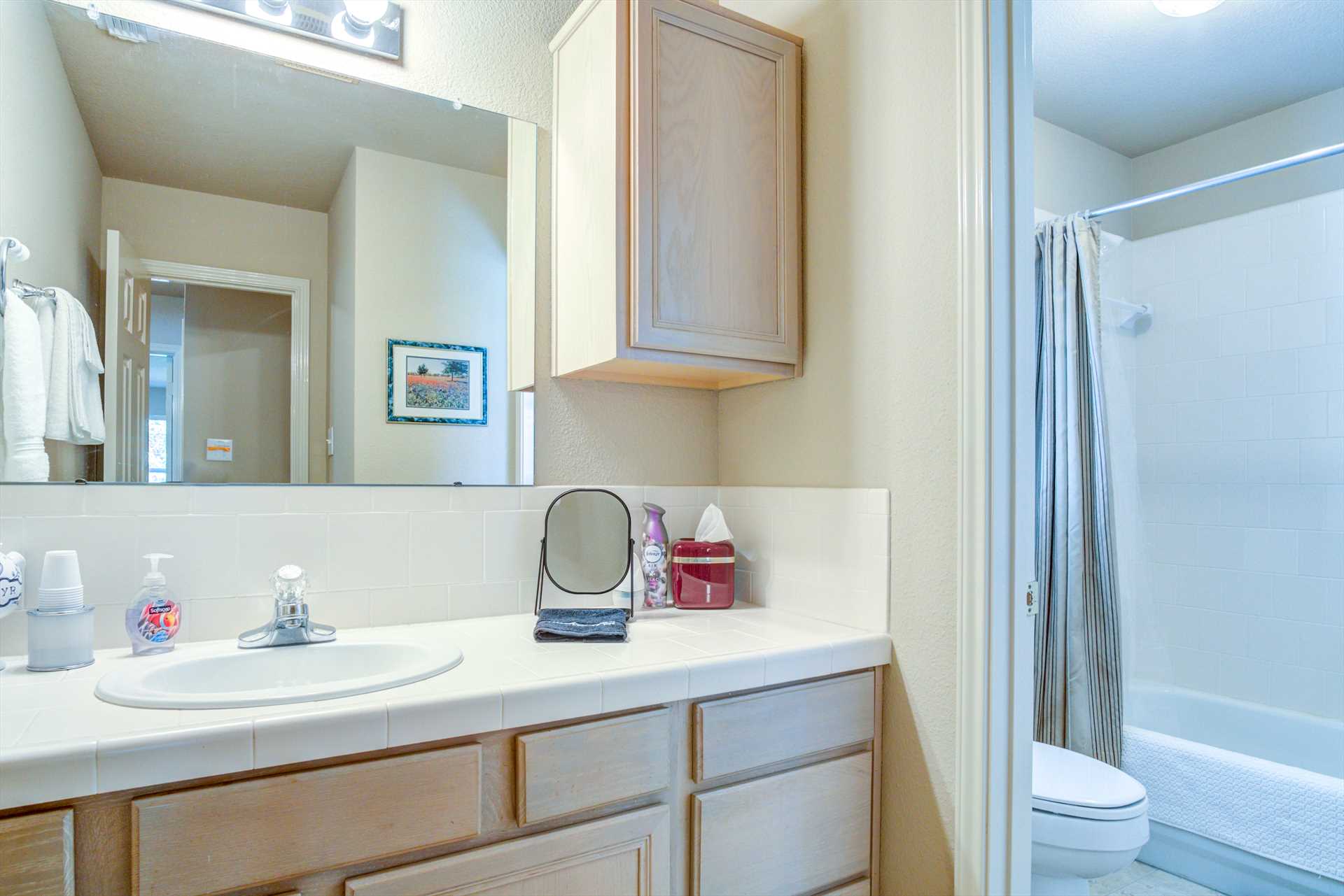                                                 The second and third bedrooms share a spotlessly-clean full bath, conveniently located in the nearby hallway.