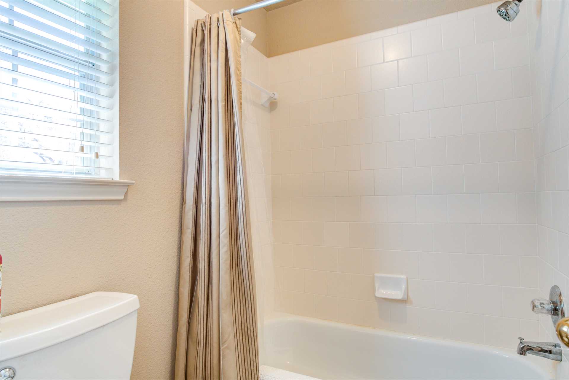                                                 The shared full bath has a tub and shower combo installed, and both bathrooms at the Retreat include fluffy and clean linens.