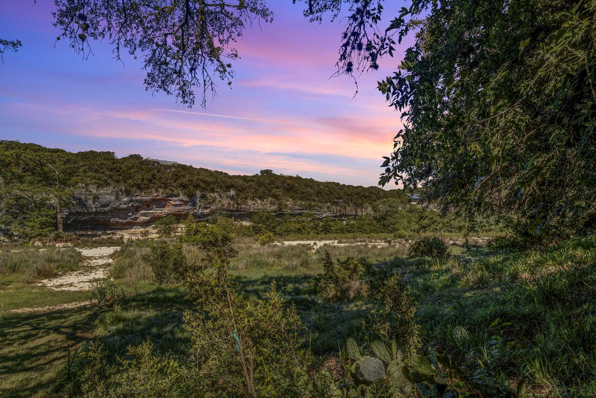                                                 Mountainous Hill Country views, brilliantly-colored sunsets, and star-filled night skies surround the River Bluff Retreat!