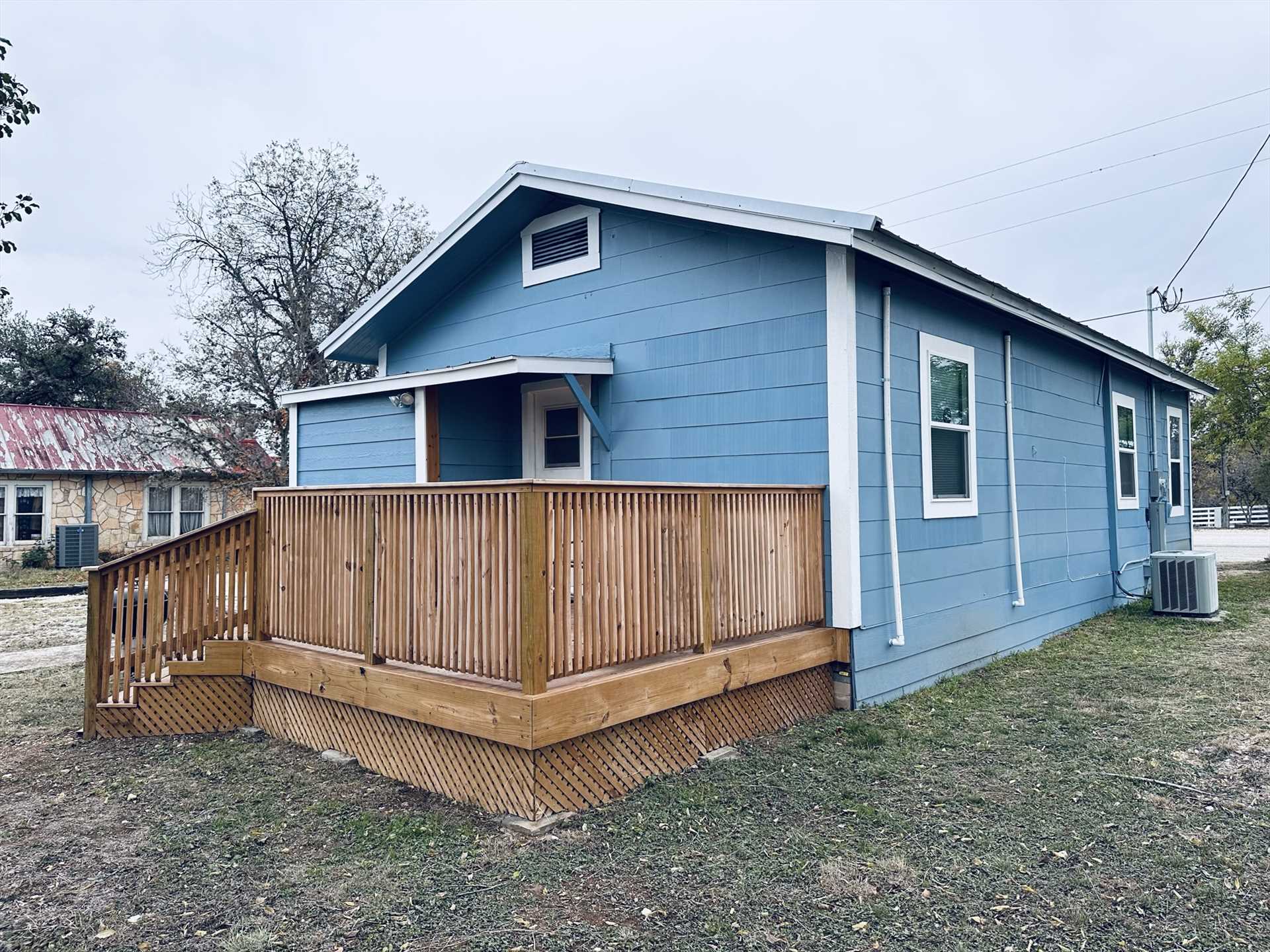                                                 Though this is an exterior shot of this pretty blue vacation home, it also shows the modern and efficient central air unit that keeps the inside just right!