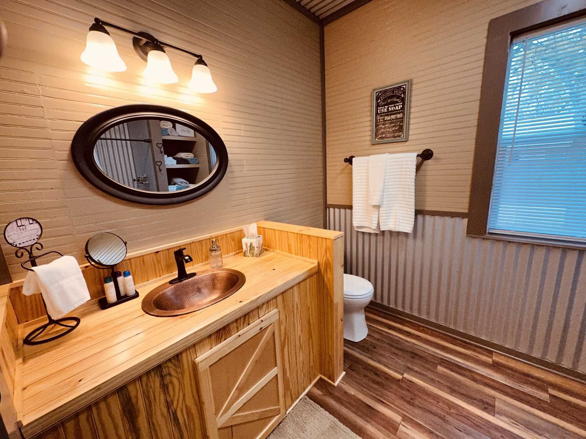                                                 A roomy vanity and tastefully-contrasting woodwork highlight the newly-remodeled full bath at the Texas Blue Apple Cottage.