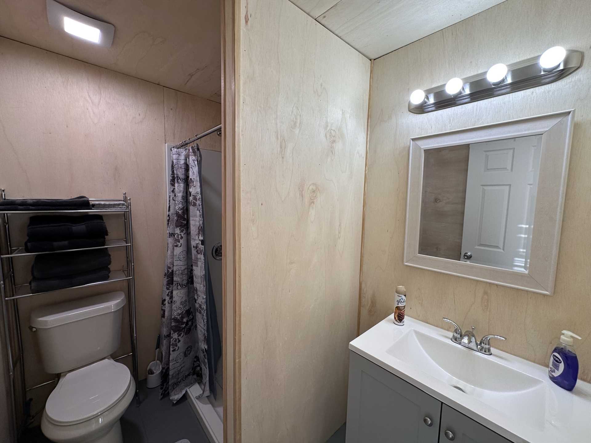                                                 A spotless single vanity and fresh linens are included in the full bath at the Wesley Cabin.