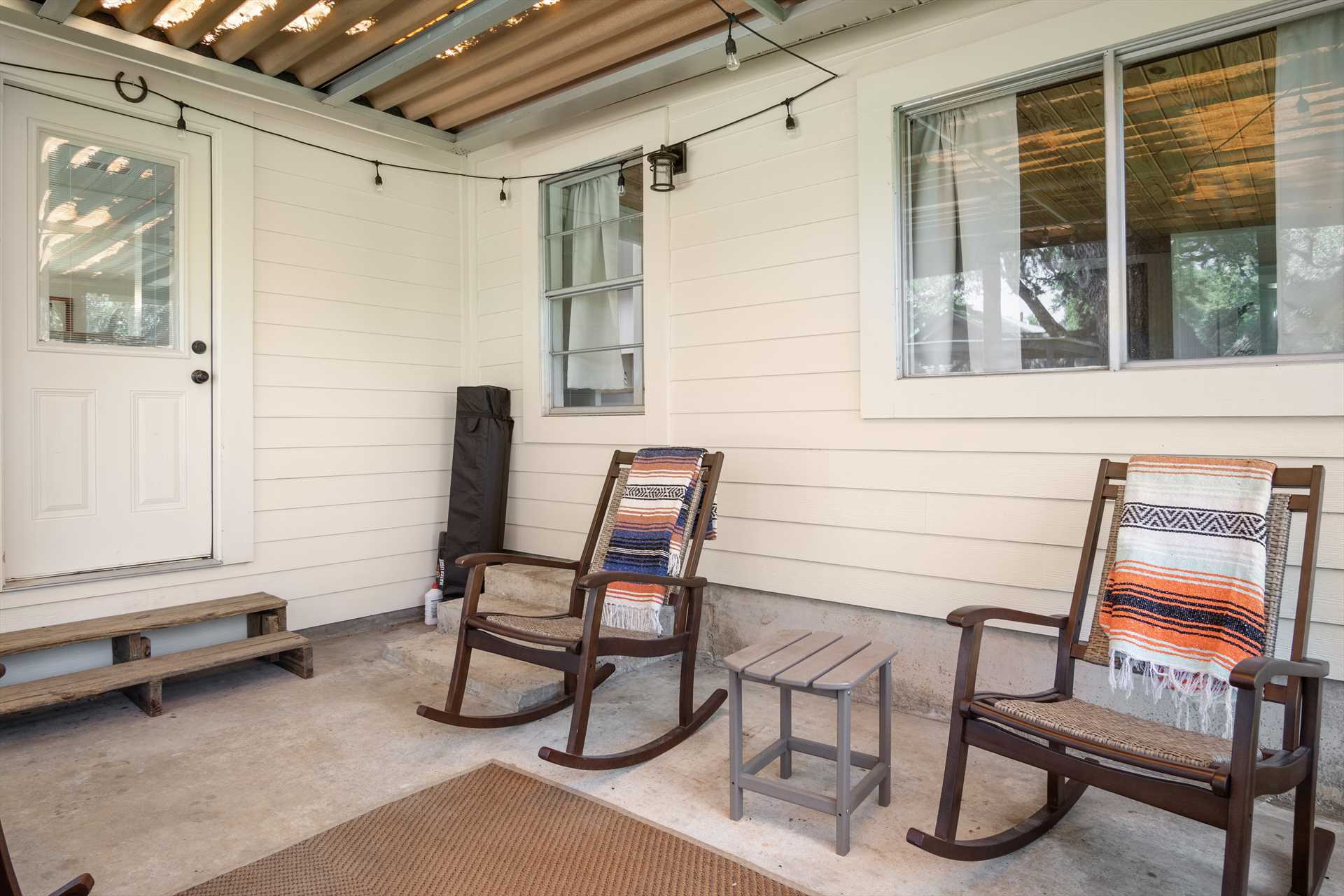                                                 You'll be comfortable inside and out! The shaded porch includes comfy furniture, and even glittering lights for atmosphere.