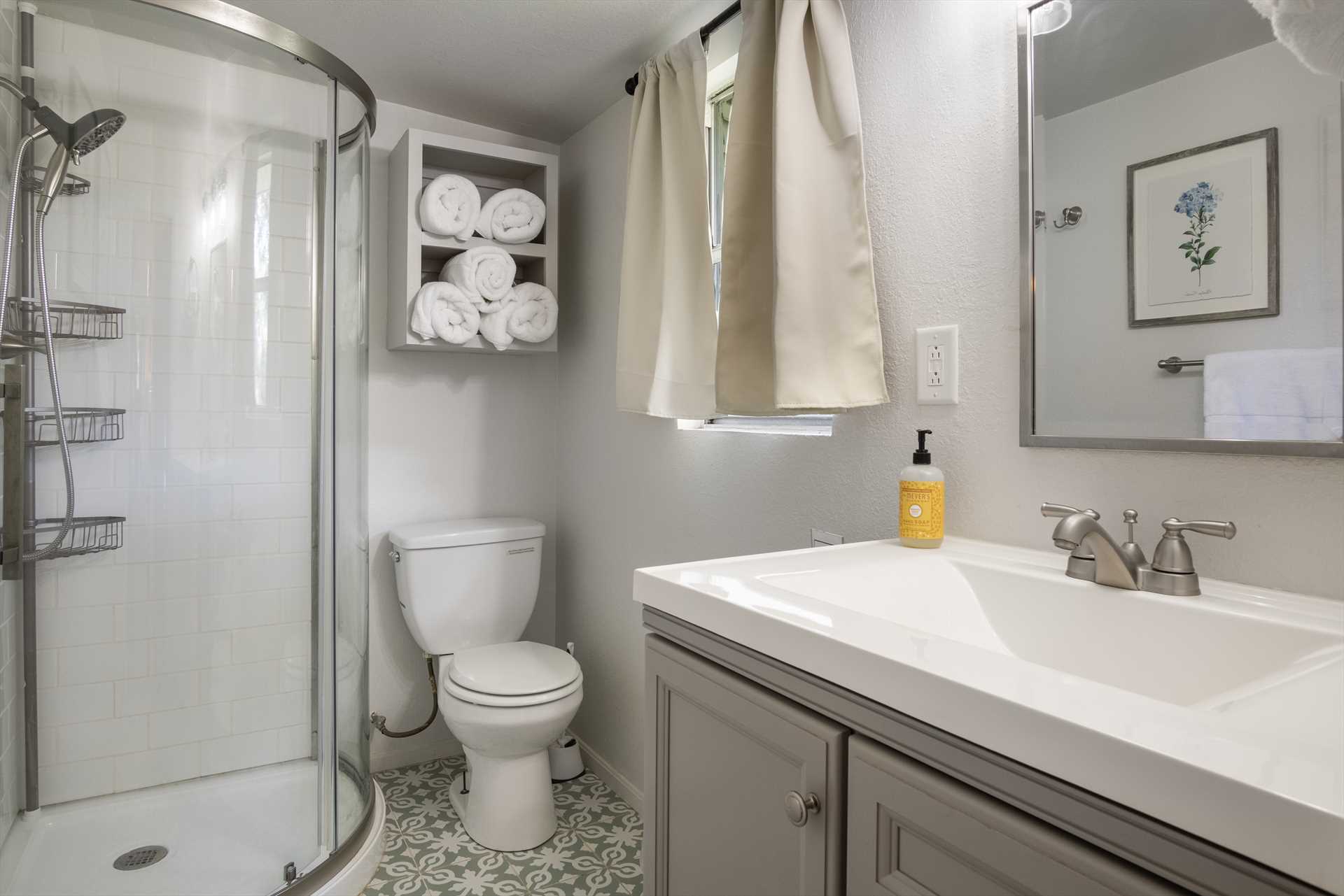                                                 A spotless full bath with a shower stall, which includes linens and basic necessities, is part of the master en suite.