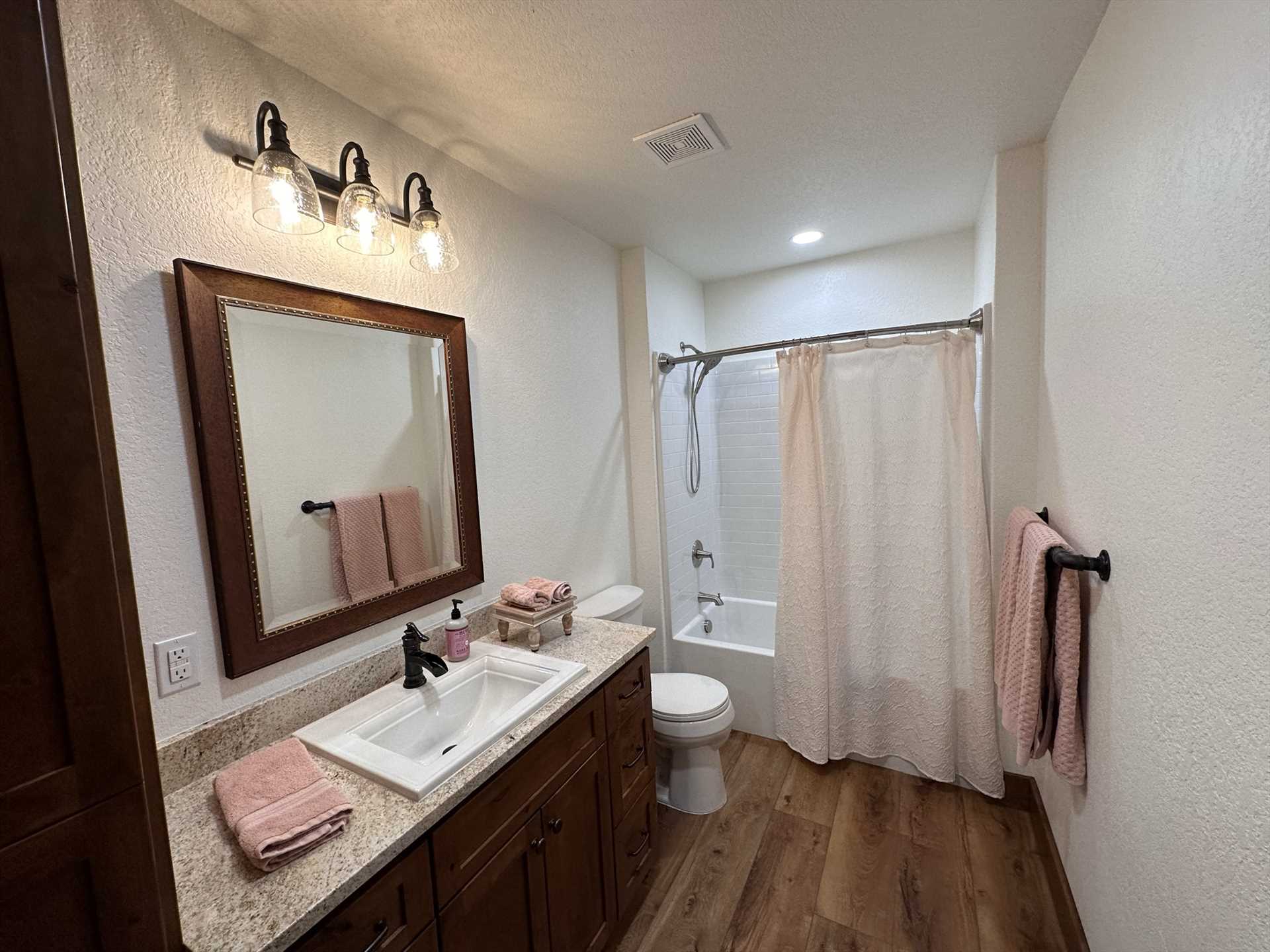                                                 The master bath has its own separate shower and tub, and the other four full baths feature shower and tub combos.