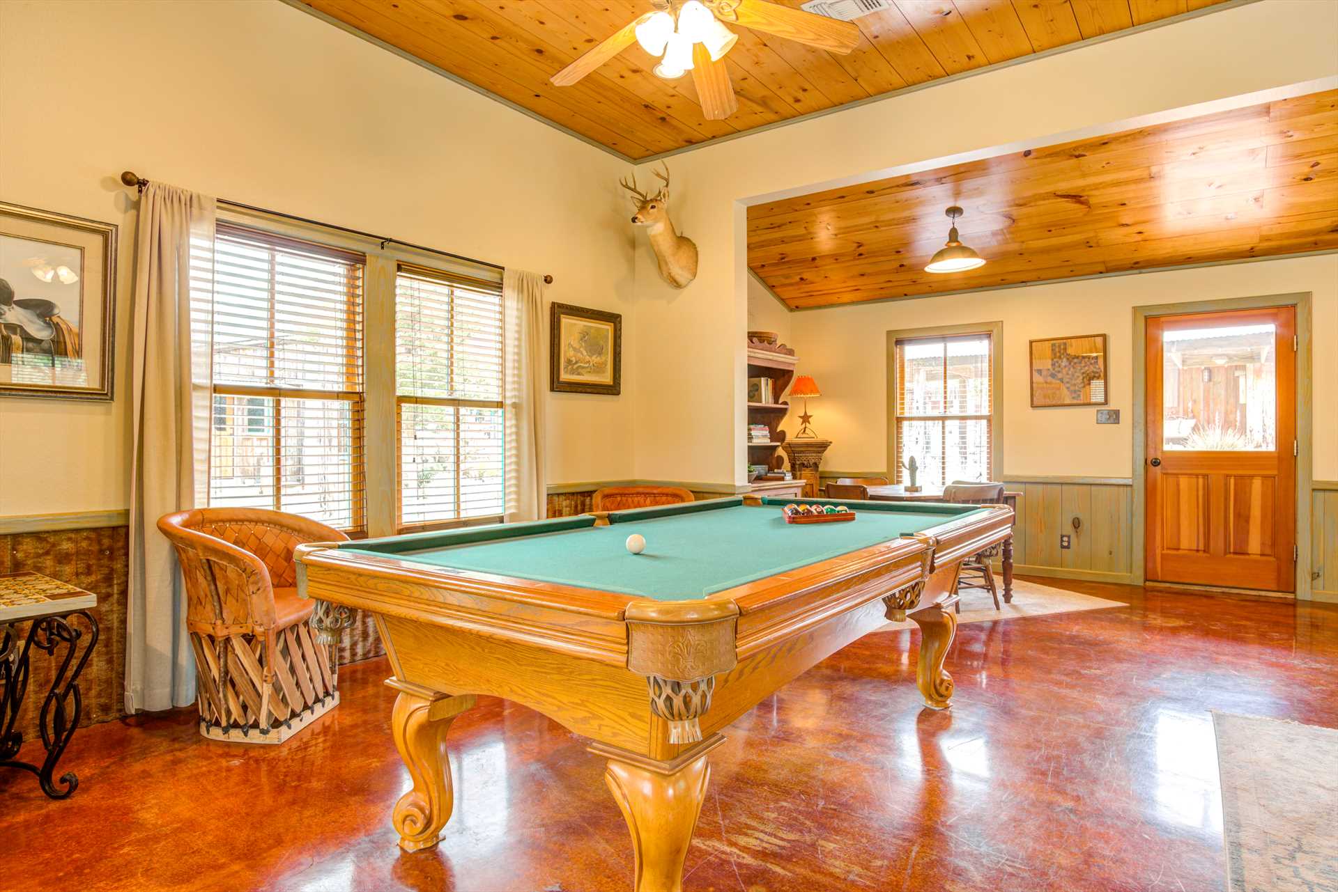                                                 With comfy chairs close by the pool table, there's no need to stand around waiting for your shot!