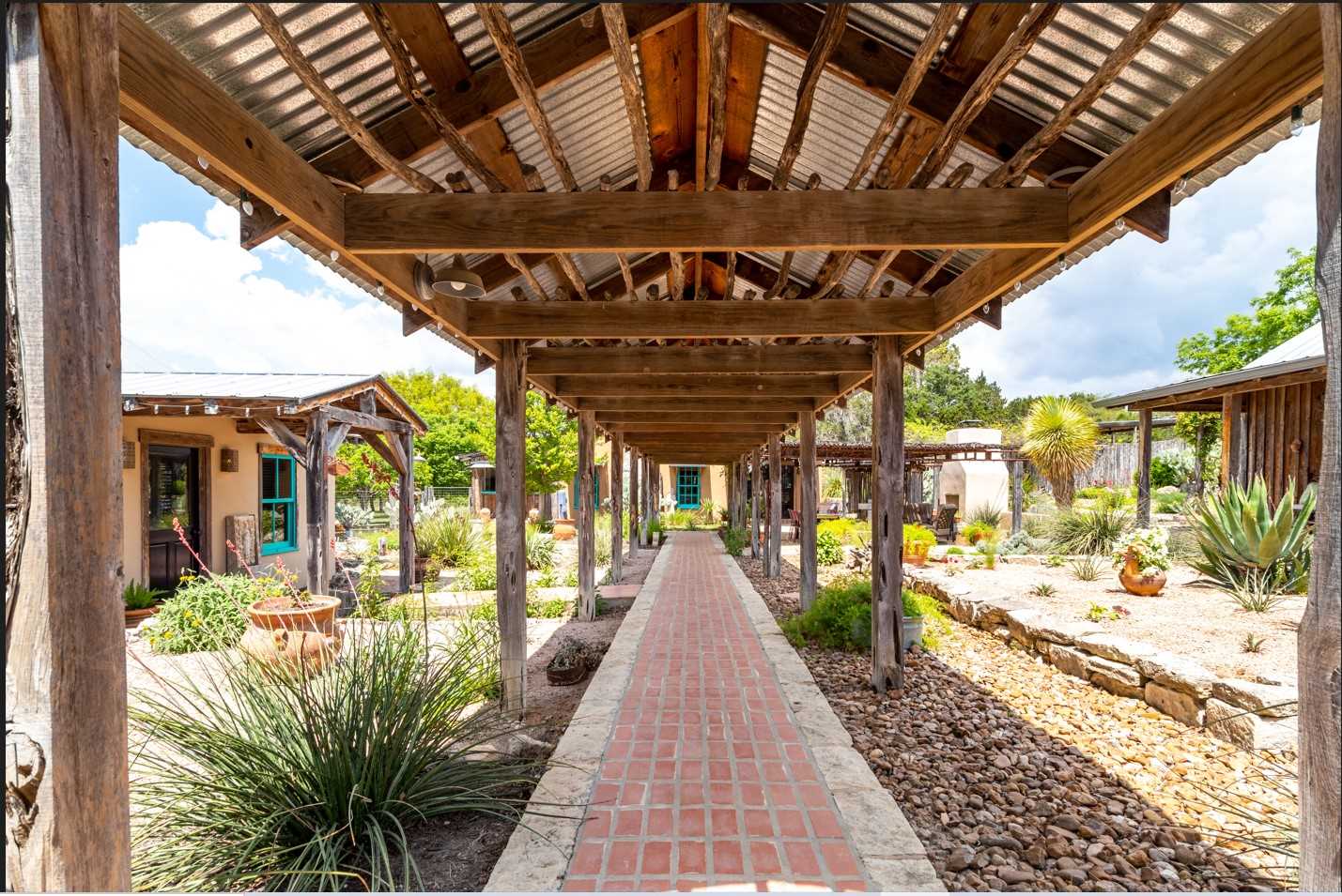                                                 The focal point of Mucho Gusto is this brick-paved breezeway, strung with glittering outdoor lighting.