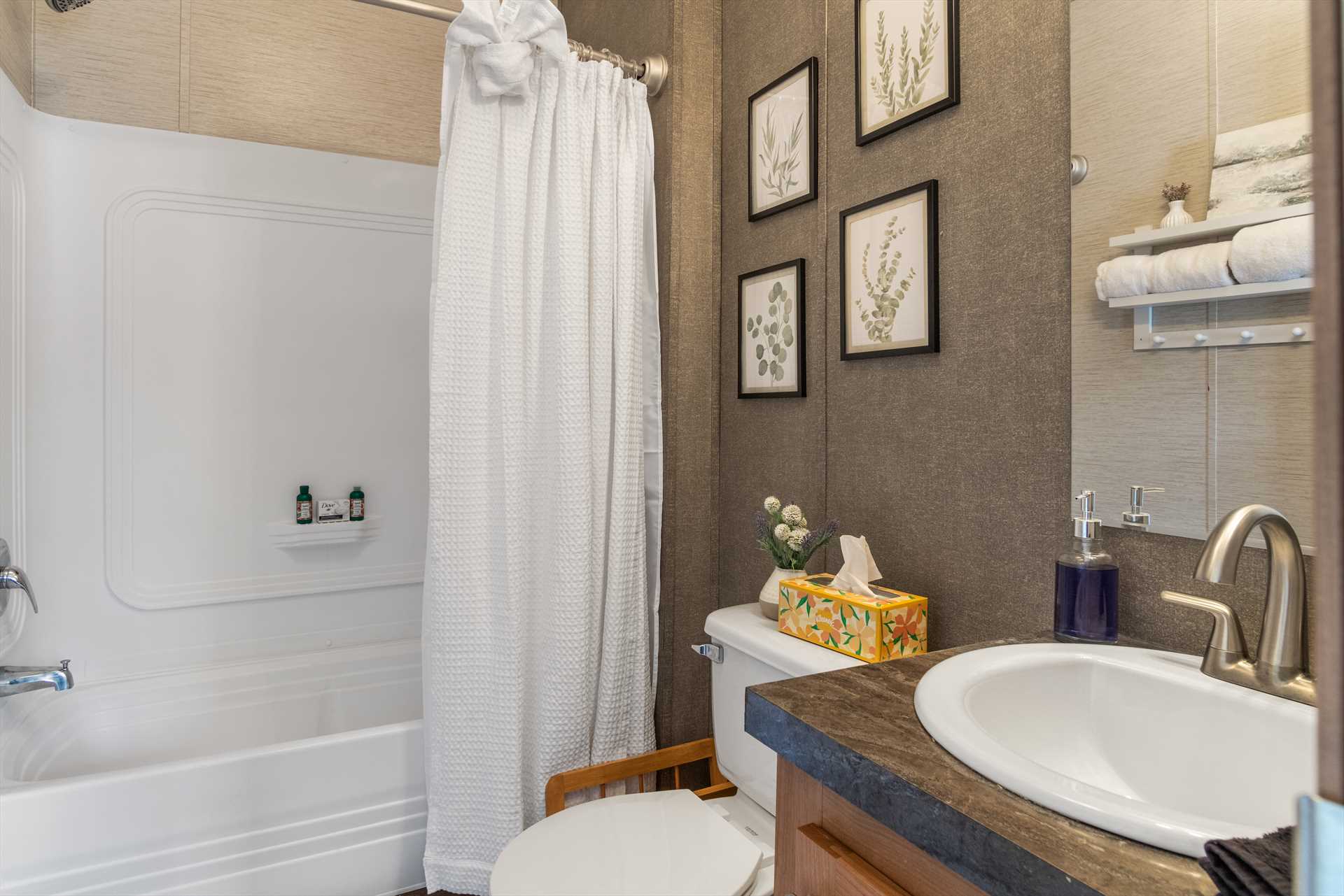                                                 The immaculately-clean full bath at Hill Country Memories includes a tub and shower combo, along with plenty of fresh linens.