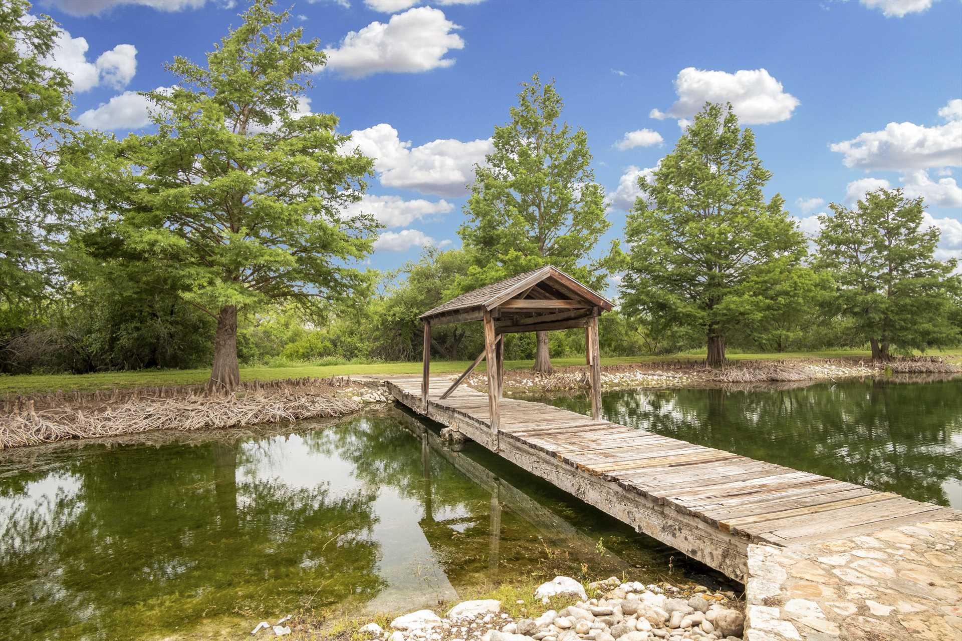                                                 The covered bridge and dock that crosses the neck of the pond is an angler's favorite for catch-and-release fishing!