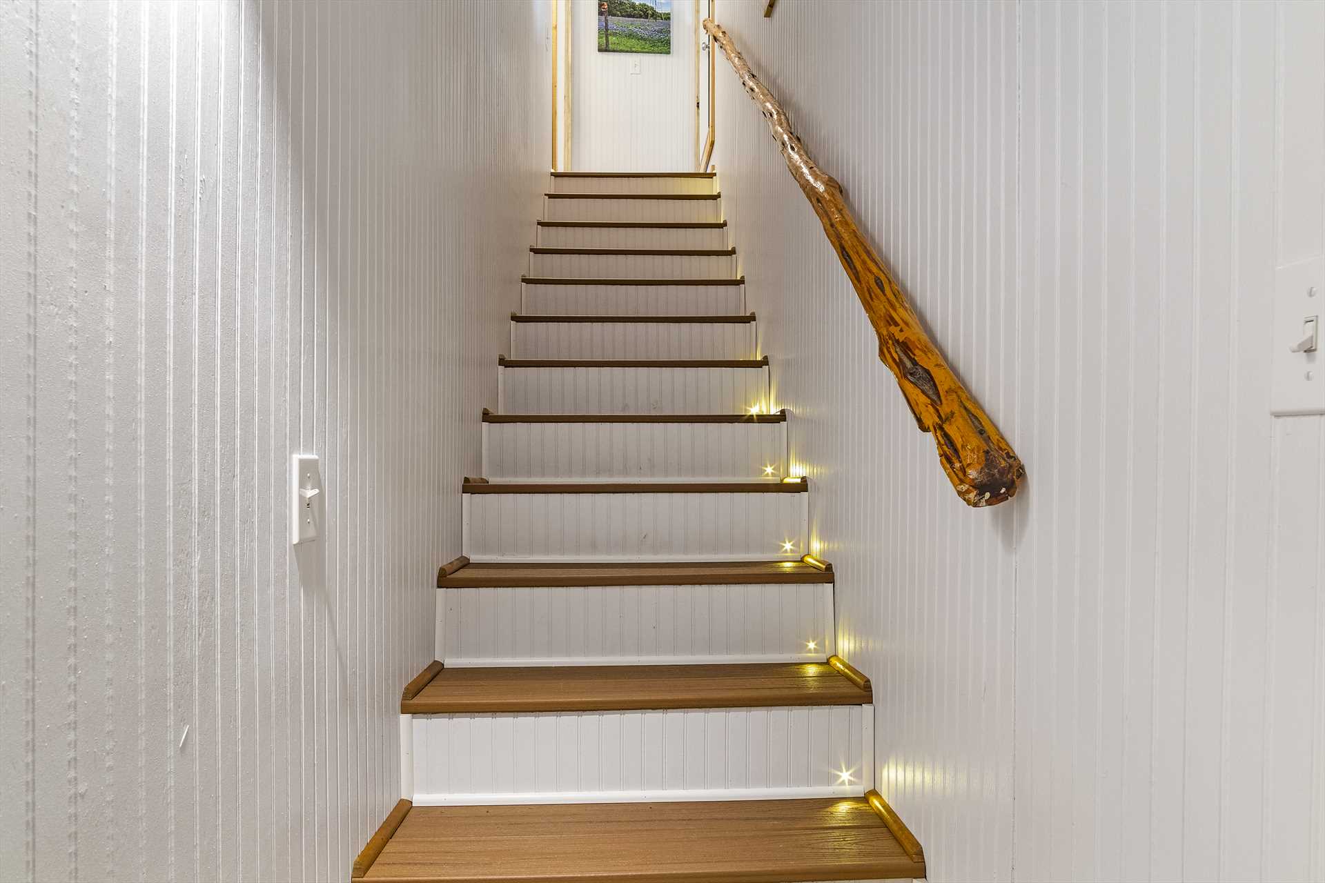                                                 Our guests love the decorative touches here! Check out the rustic banister and helpful stair lights as you head upstairs.