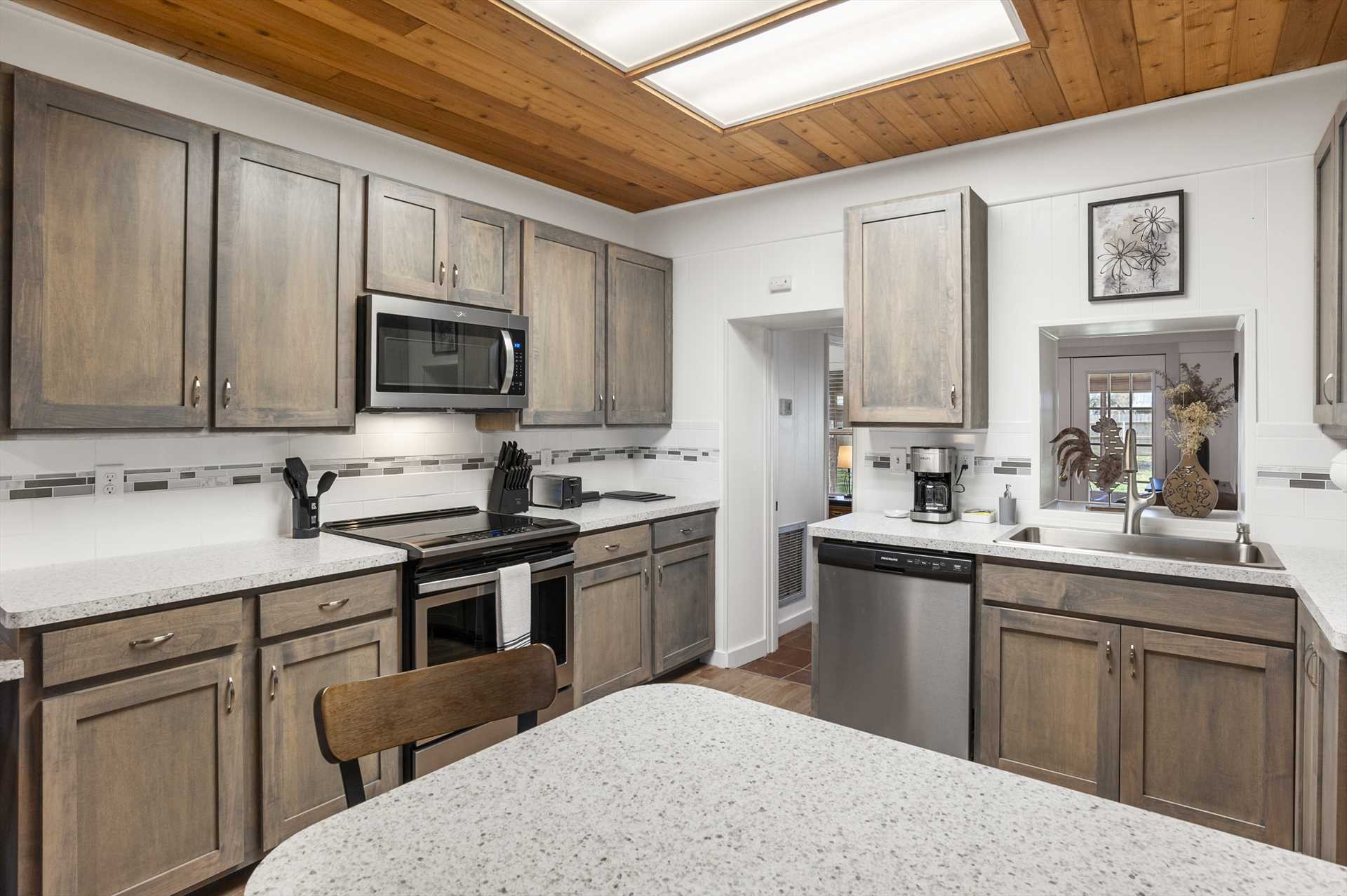                                                 The newly-remodeled kitchen includes an oven, microwave, fridge, dishwasher, coffee maker, and toaster!
