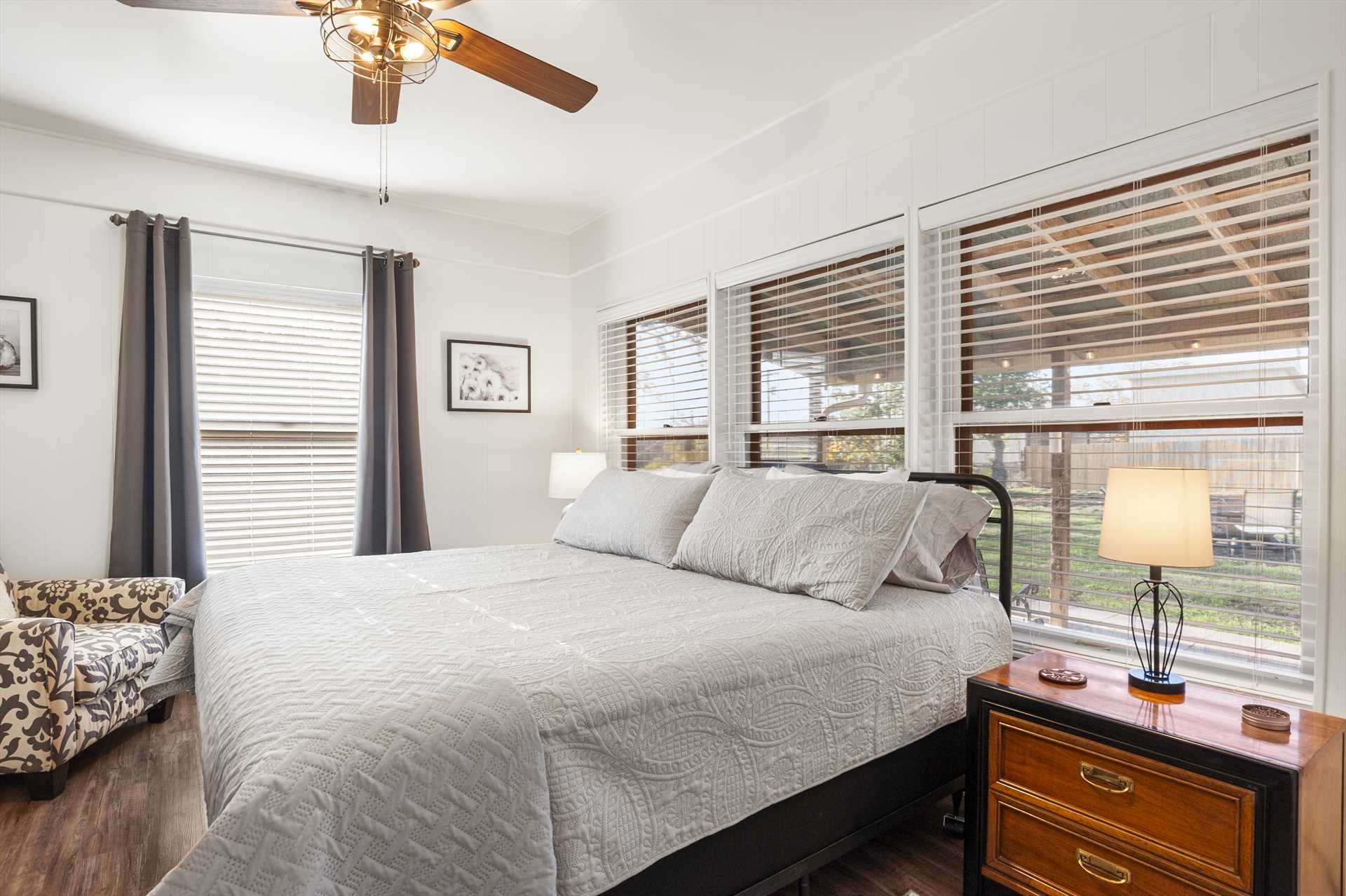                                                 A soft and roomy king-sized bed graces the first bedroom here, with big windows that welcome natural light into the room.