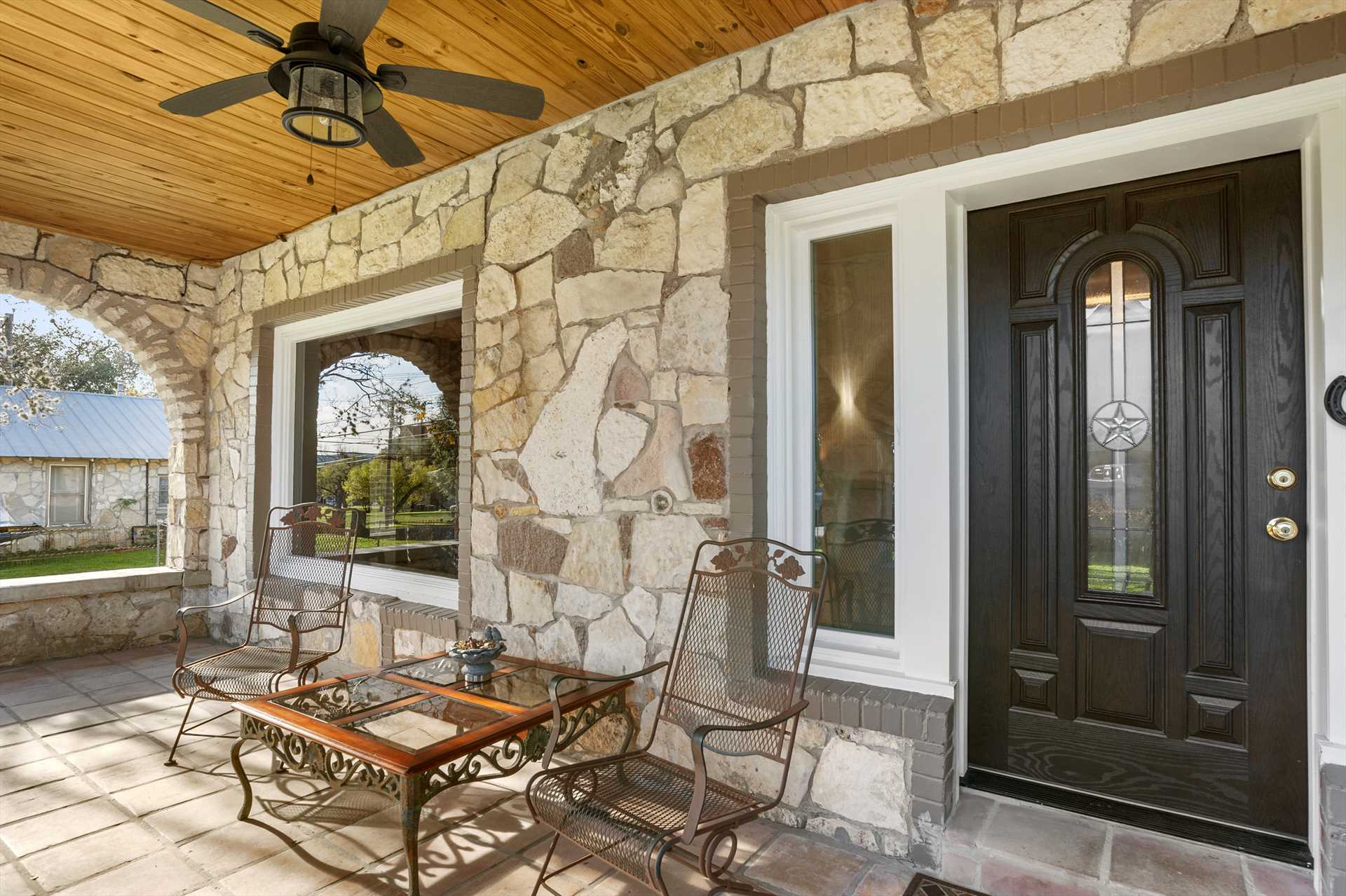                                                The front patio is nicely shaded, with a ceiling fan to stir up a fresh breeze if you need one!